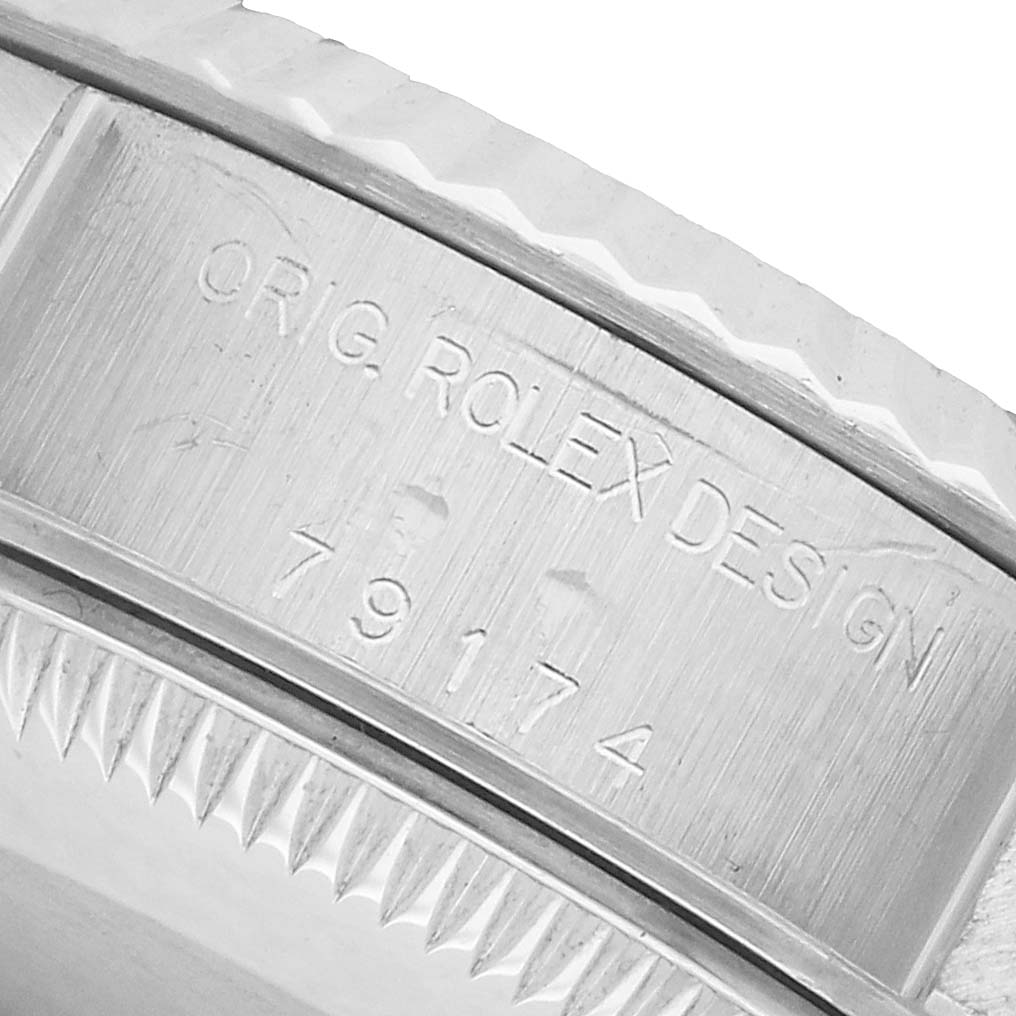 The close-up image of the Rolex Datejust 79174 Women's Stainless Steel White Dial shows the inner rim of the case with engraved model details.