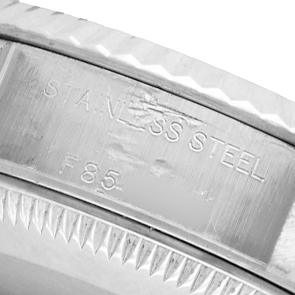 The image shows a close-up of the inner bezel engraving of a Rolex Datejust 79174 Women's Stainless Steel White Dial, highlighting the "STAINLESS STEEL" marking.