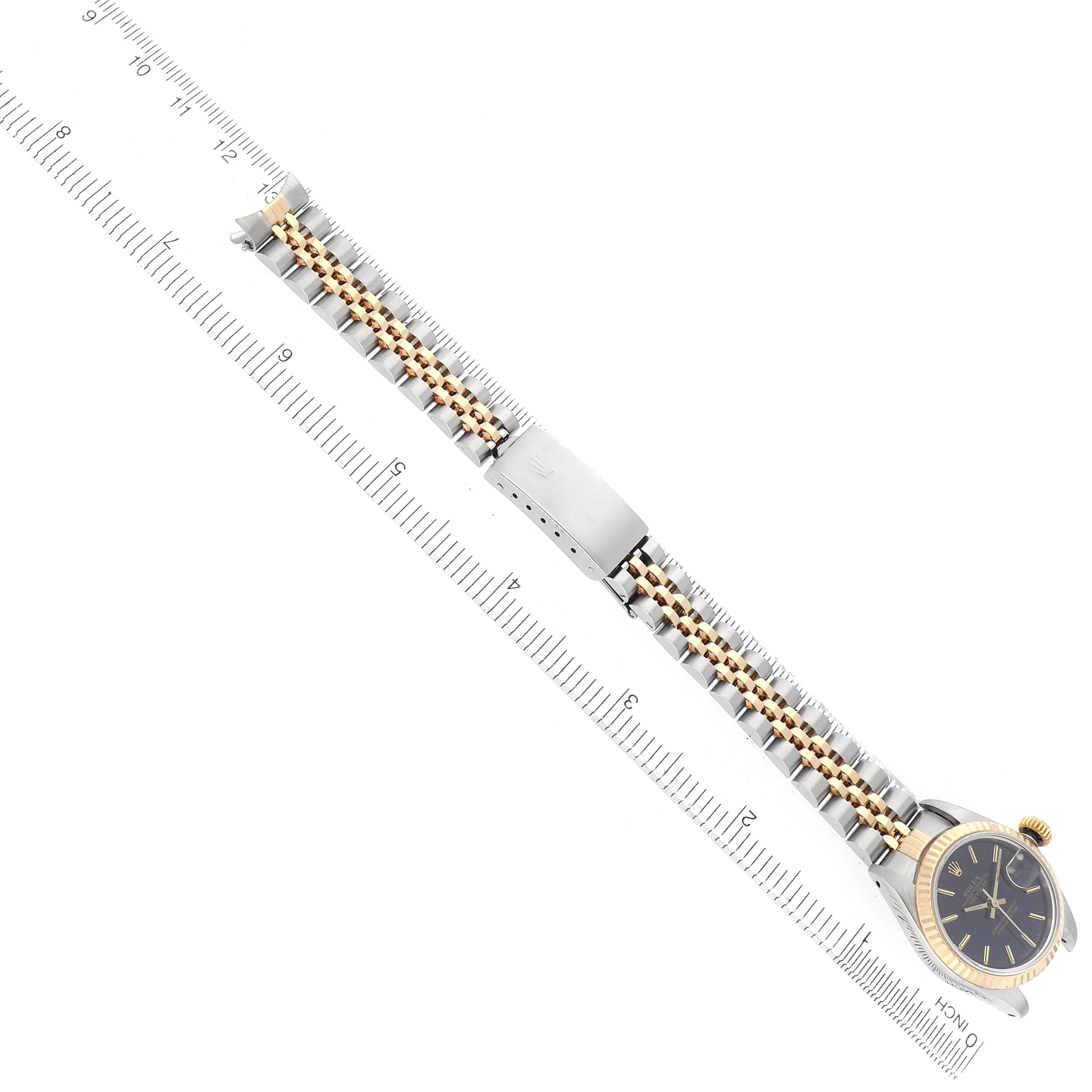 The image shows a Rolex Datejust 69173 Women's Steel and Gold (two tone) Black Dial watch from a top-down angle, highlighting the bracelet, clasp, and bezel.