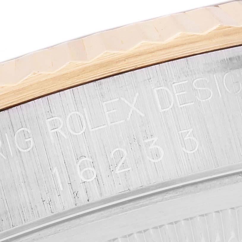 The image shows a close-up of the side engraving on a Rolex Datejust 16233 Men's Steel and Gold (two tone) Blue Dial 16233 Men's Steel and Gold (two tone) Blue Dial model, displaying part of the bezel.