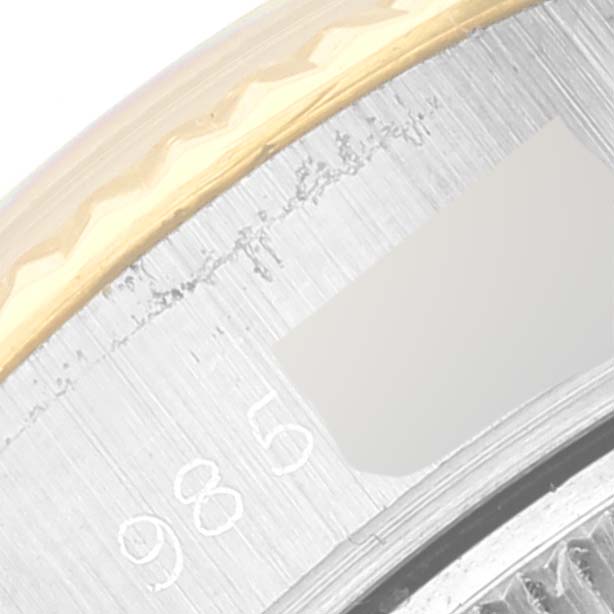 The image shows a close-up of the Datejust model by Rolex, focusing on the bezel and part of the inner fluted ring with numerals.