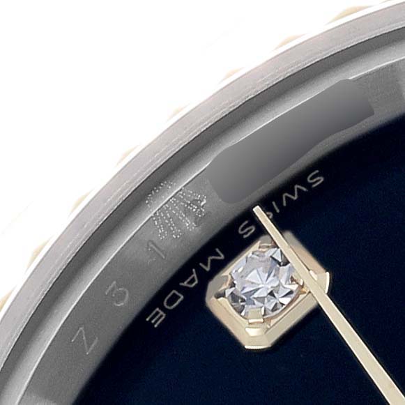 The image shows a close-up of the dial edge and a diamond marker on a Rolex Datejust 179173 Women's Steel and Gold (two tone) Black Dial watch.