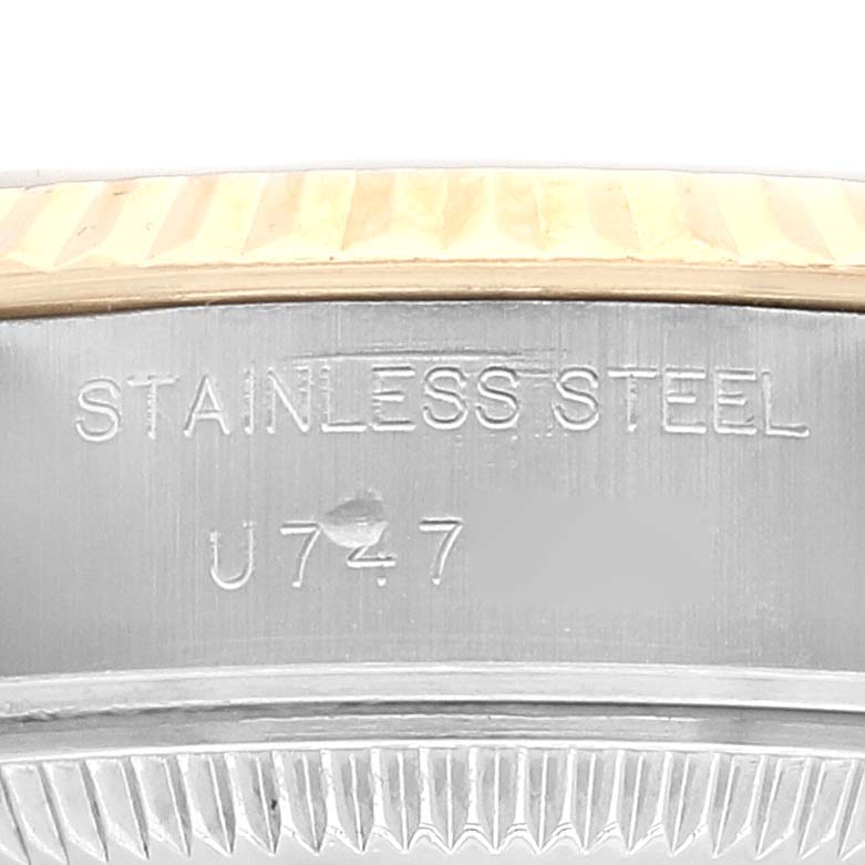 This image shows a close-up of the case side and bezel of a Rolex Datejust 69173 Women
s Steel and Gold (two tone) Grey Dial 69173 Women
s Steel and Gold (two tone) Grey Dial model, with "STAINLESS STEEL" engraved on it.