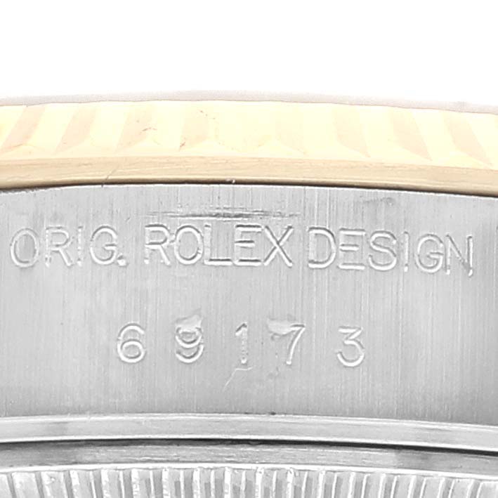 This image shows a close-up of the Rolex Datejust 69173 Women
s Steel and Gold (two tone) Grey Dial 69173 Women
s Steel and Gold (two tone) Grey Dial model
s case, highlighting the “ORIG. ROLEX DESIGN” engraving and model number 69173.