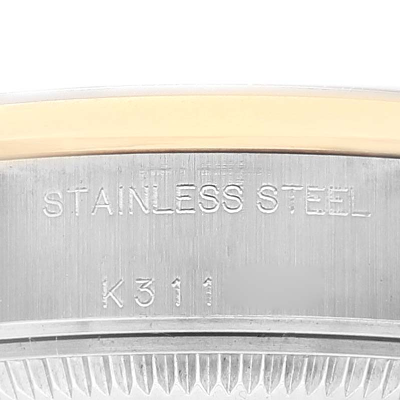 This image shows a close-up of the case back edge of a Rolex Datejust 79163 Women's Steel and Gold (two tone) Mother of Pearl Dial 79163 Women's Steel and Gold (two tone) Mother of Pearl Dial watch, highlighting the "STAINLESS STEEL" engraving.