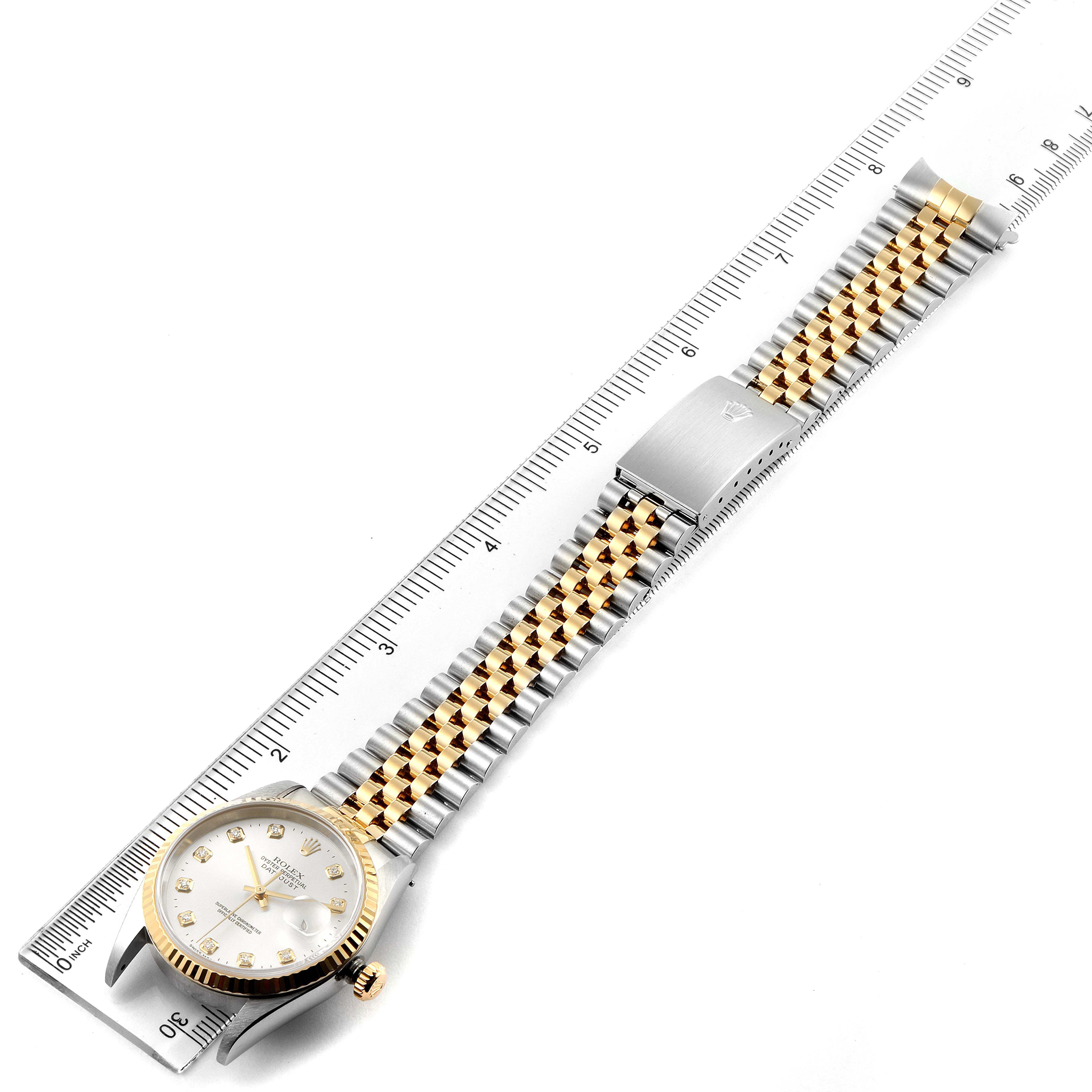 The image shows a Rolex Datejust 16233 Men's Steel and Gold (two tone) Silver Dial 16233 Men's Steel and Gold (two tone) Silver Dial watch from a top-down angle, displaying the watch face, band, and clasp next to a ruler.