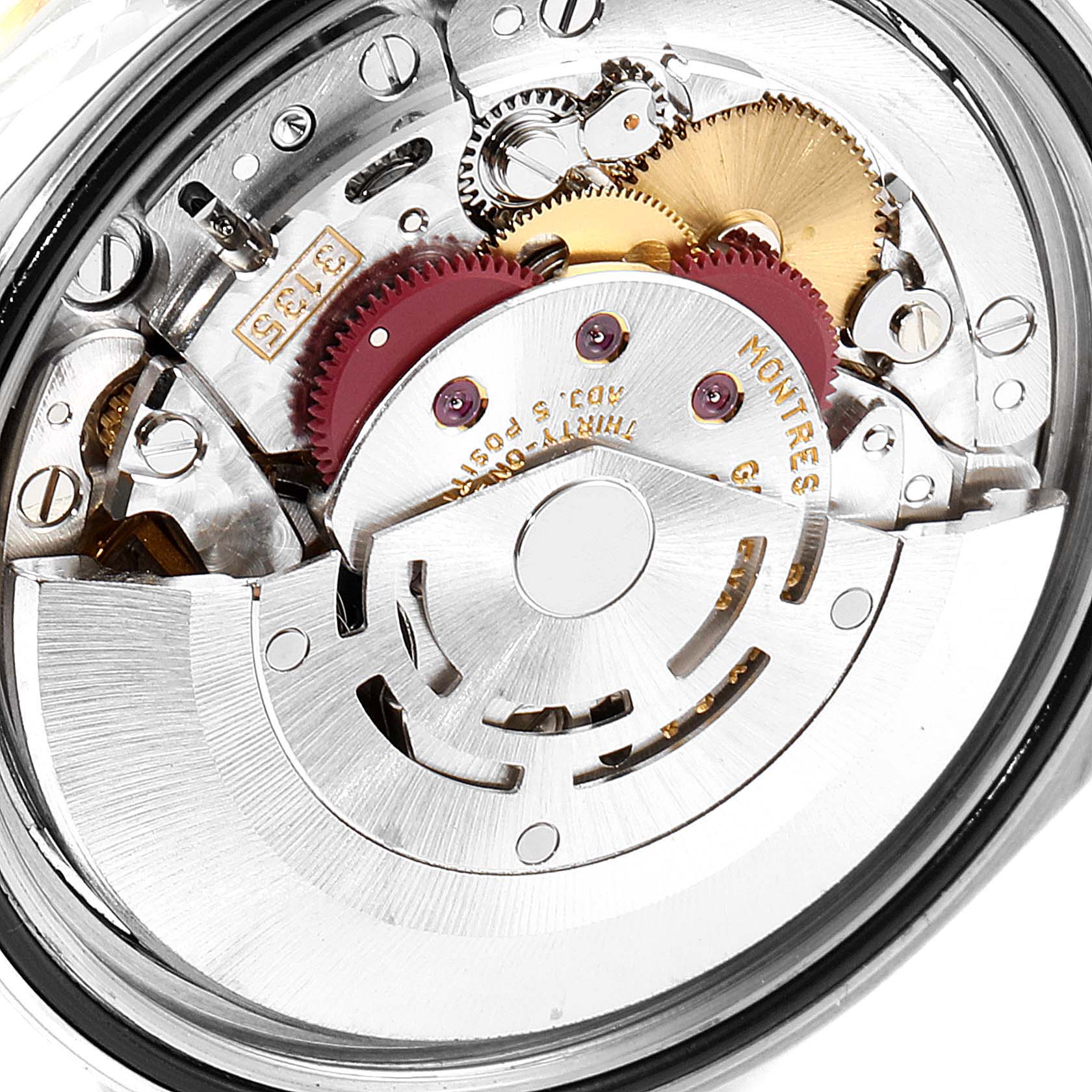 This is an interior view of the Rolex Datejust 16233 Men's Steel and Gold (two tone) Silver Dial 16233 Men's Steel and Gold (two tone) Silver Dial watch showing its intricate mechanical movement and gears.