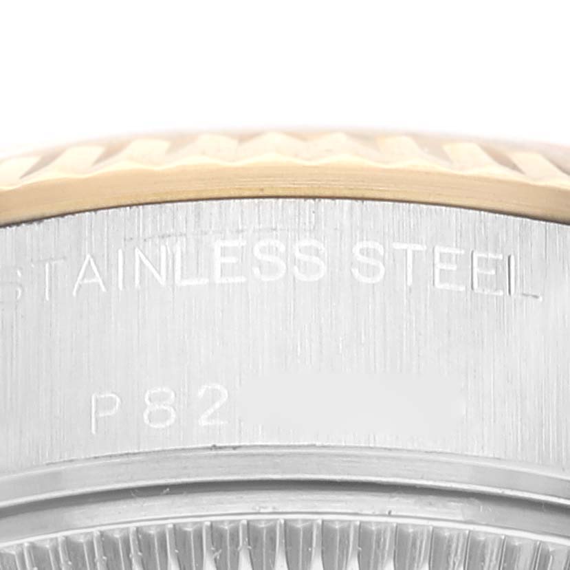 The image shows a close-up of the case back and part of the bezel of a Rolex Datejust 79173 Women's Steel and Gold (two tone) White Dial 79173 Women's Steel and Gold (two tone) White Dial watch, highlighting the "STAINLESS STEEL" engraving.