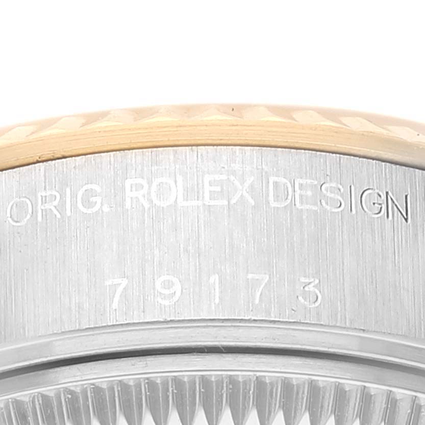 The image shows a close-up of the side of a Rolex Datejust 79173 Women's Steel and Gold (two tone) White Dial 79173 Women's Steel and Gold (two tone) White Dial watch case, highlighting the "ORIG. ROLEX DESIGN" engraving.