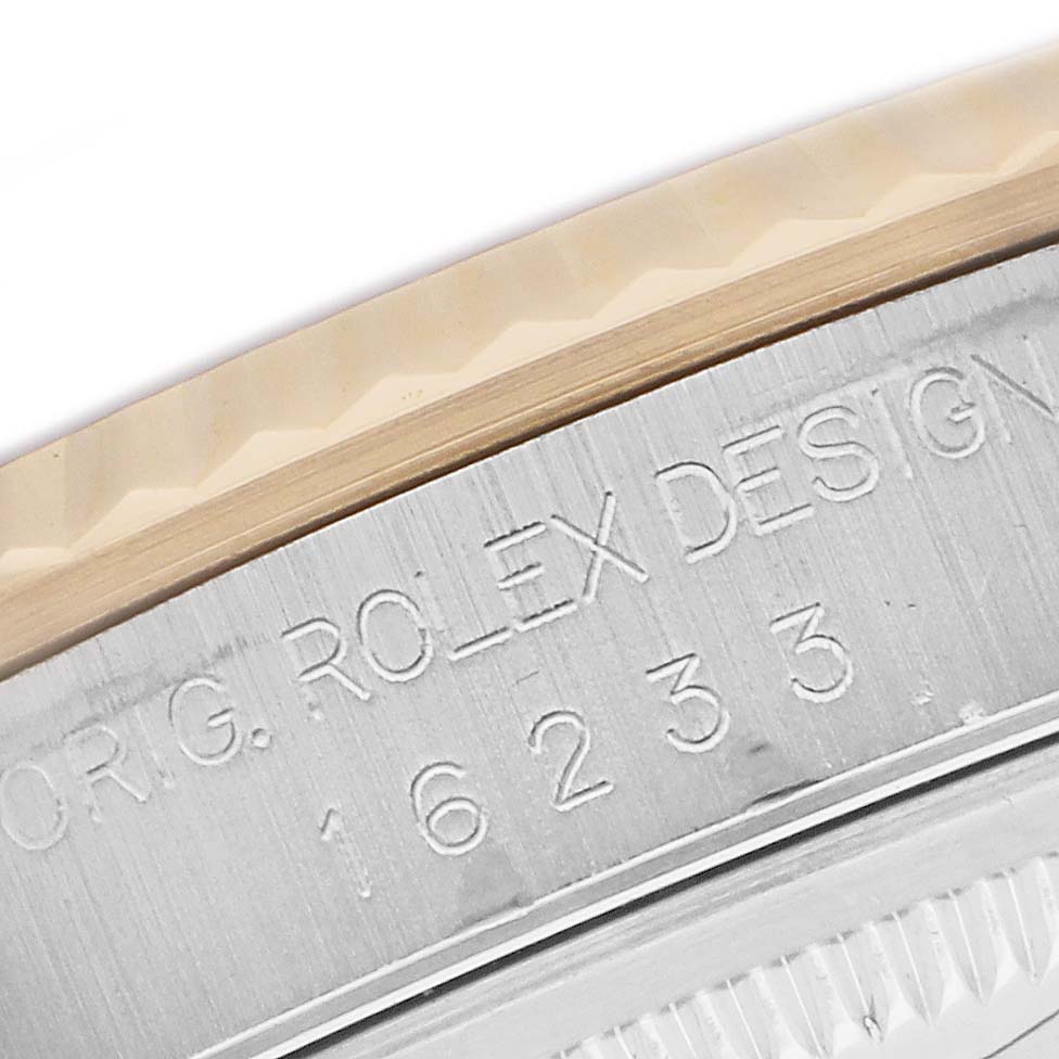 The image shows a close-up of the side of a Rolex Datejust 16233 Men's Steel and Gold (two tone) White Dial watch, featuring engravings and part of the bezel.