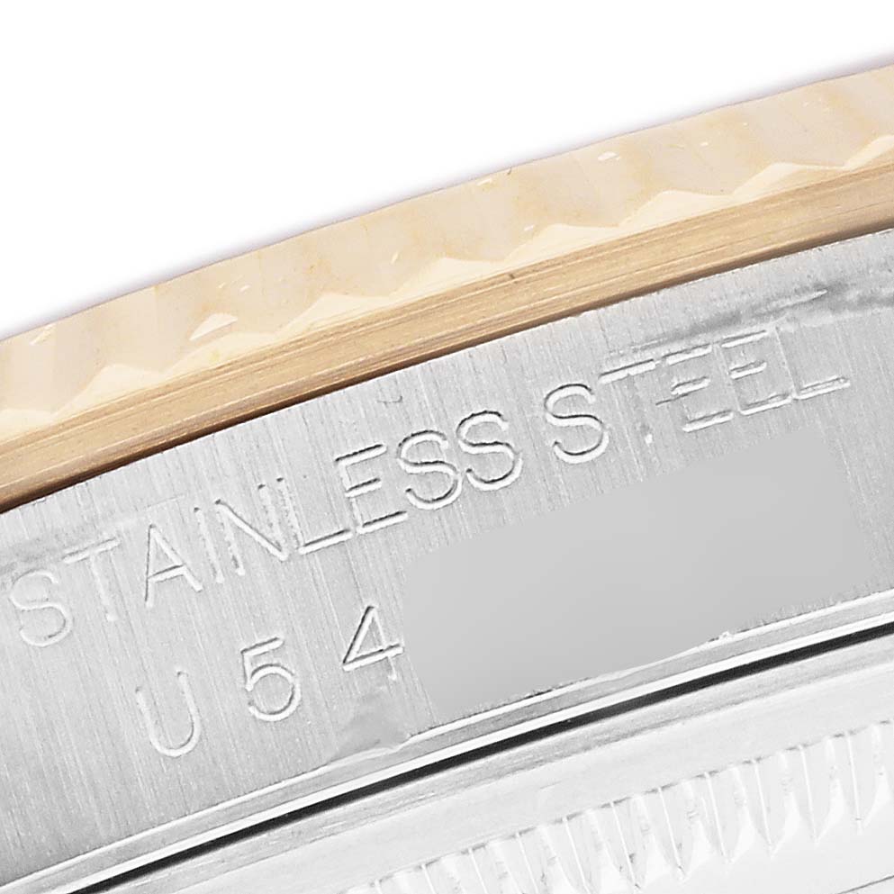 The image shows a close-up of the Rolex Datejust 16233 Men's Steel and Gold (two tone) White Dial's watch case edge, showcasing the "STAINLESS STEEL" engraving.