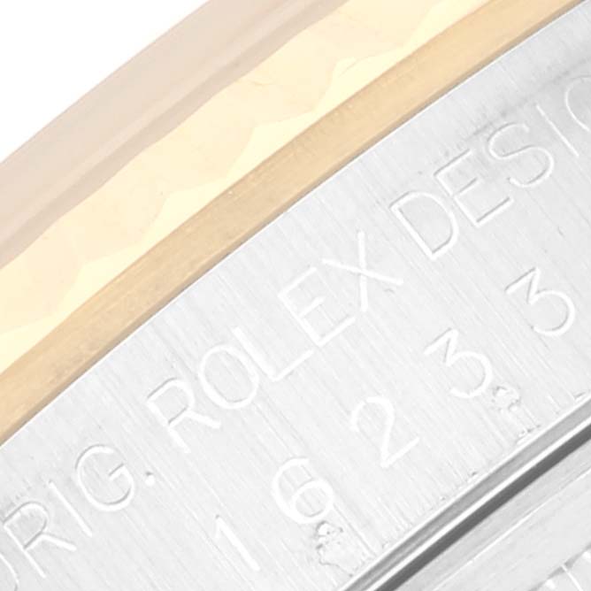 The image shows a close-up angle of the bezel and case, with engraved text on the Rolex Datejust 16233 Men's Steel and Gold (two tone) White Dial 16233 Men's Steel and Gold (two tone) White Dial watch.