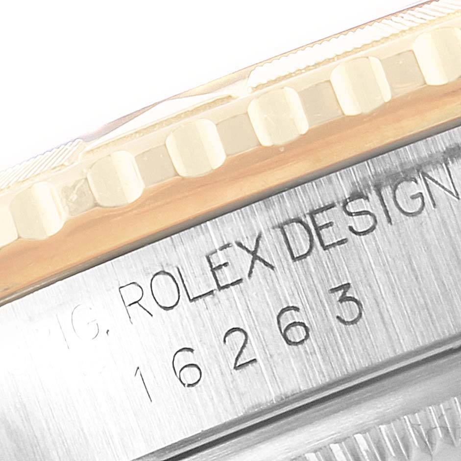 This image shows a close-up of the Rolex Turn-o-Graph 16263 Men
s Steel and Gold (two tone) White Dial 16263 Men
s Steel and Gold (two tone) White Dial model casing with engraved design details and part of the bezel.