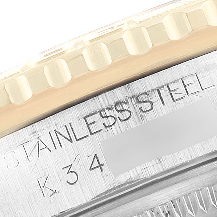 This close-up image of the Rolex Turn-o-Graph 16263 Men
s Steel and Gold (two tone) White Dial 16263 Men
s Steel and Gold (two tone) White Dial model shows the bezel and engraved "STAINLESS STEEL" text, including part of the serial number.