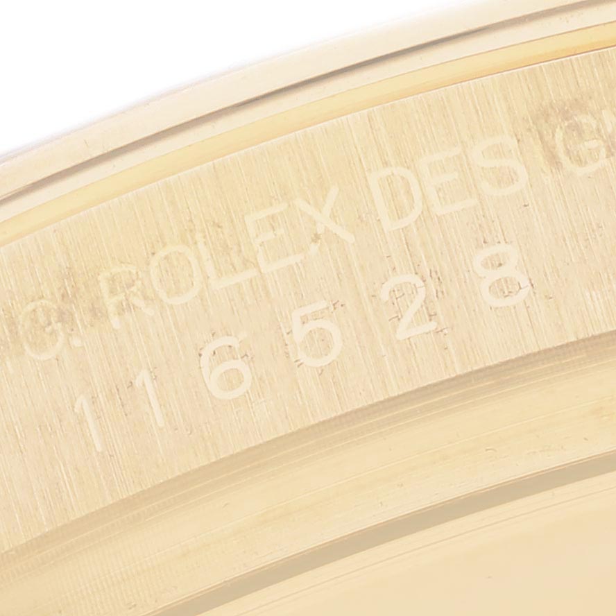 The image shows a close-up of the engraved serial number inside the bezel of a Rolex Daytona 116528 Men's Yellow Gold Mother of Pearl Dial watch.