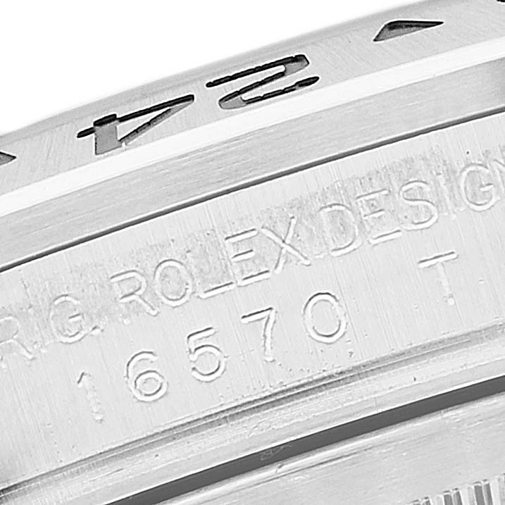 The image shows an angled close-up of the bezel and the engraved case of a Rolex Explorer 16570 Men
s Stainless Steel White Dial 16570 Men
s Stainless Steel White Dial model with the reference number 16570.