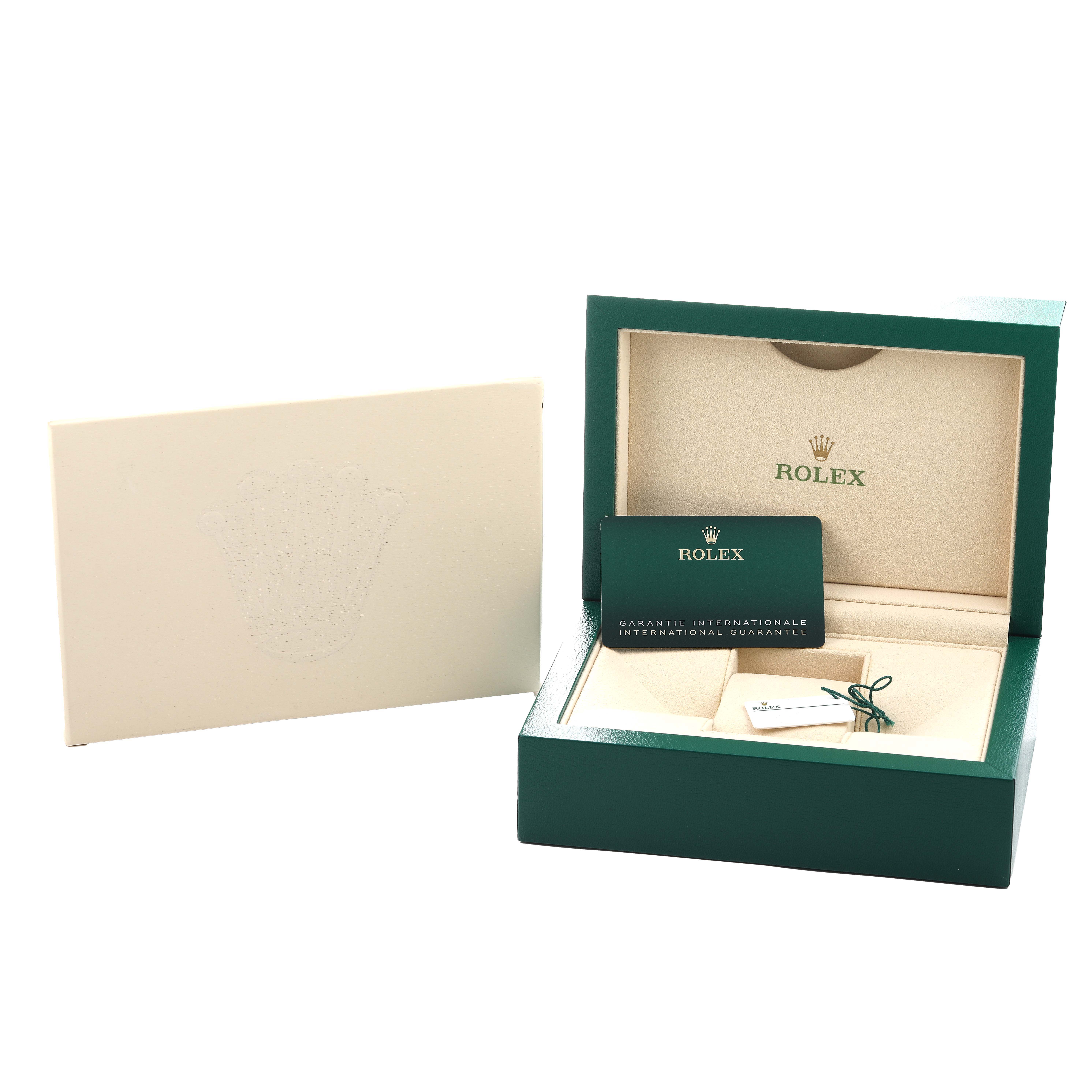 The image shows the open box and accessories for a Rolex Explorer 226570 Men
s Stainless Steel White Dial, including a warranty card and tags.