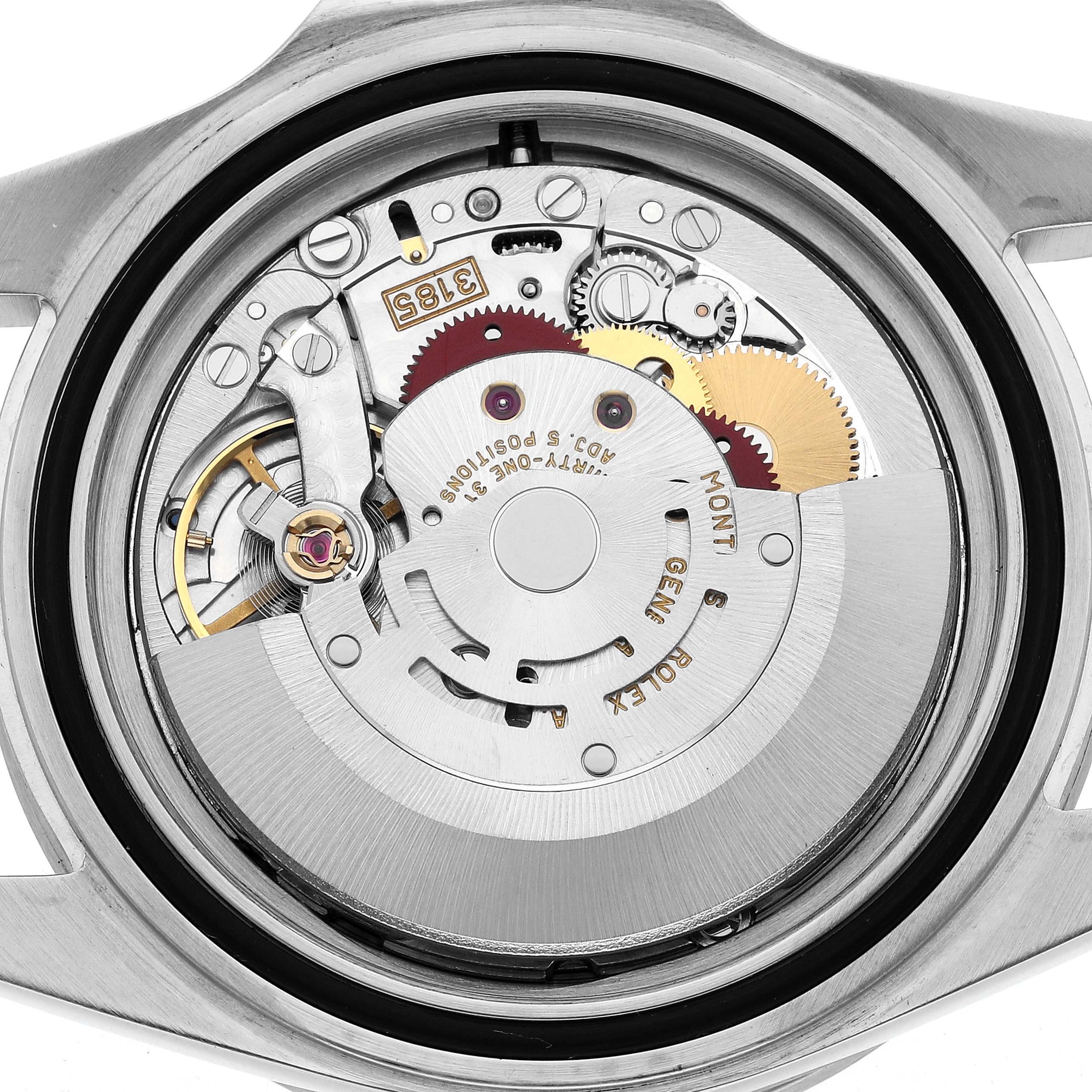 The image shows the internal mechanism of a Rolex Explorer 16570 Men's Stainless Steel Black Dial watch from a back angle, revealing the movement and gears.
