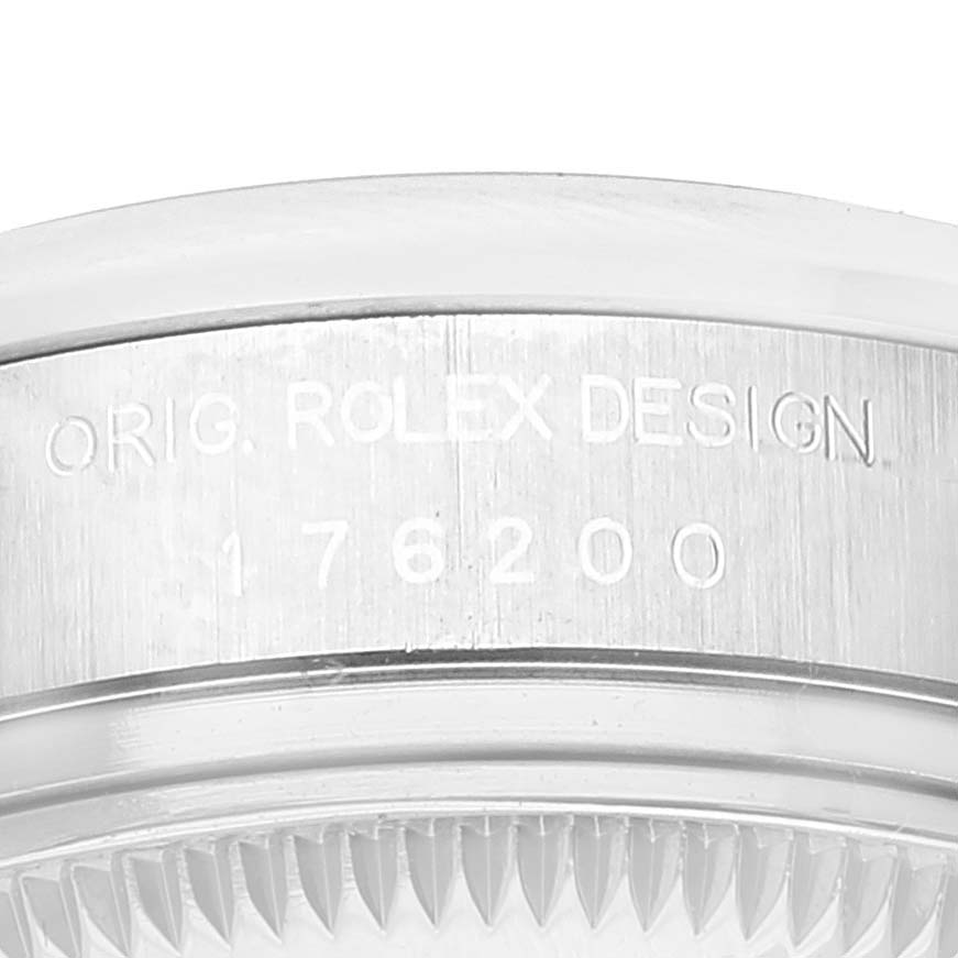 This image shows a close-up of the side engraving on an Oyster Perpetual Rolex watch case, displaying the serial number and branding.