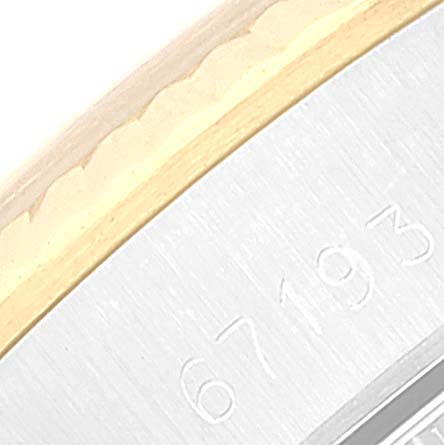 This image shows a close-up view of the case and engraving of a Rolex Oyster Perpetual 67193 Women's Steel and Gold (two tone) Champagne Dial 67193 Women's Steel and Gold (two tone) Champagne Dial watch model.