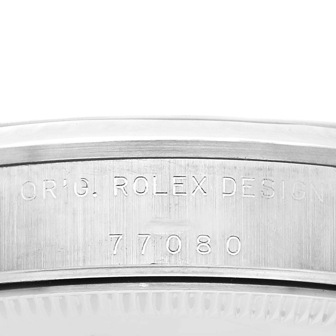 The image shows a close-up of the Rolex Oyster Perpetual 77080 Women's Stainless Steel Black Dial case side, highlighting the engraved model number.