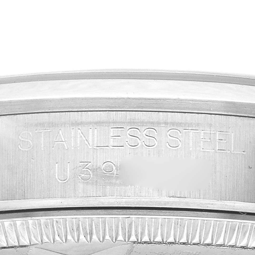 The image shows the side of a Rolex Mid-Size 67480 Women's Stainless Steel Pink Dial model, highlighting the engraved text on the stainless steel case.