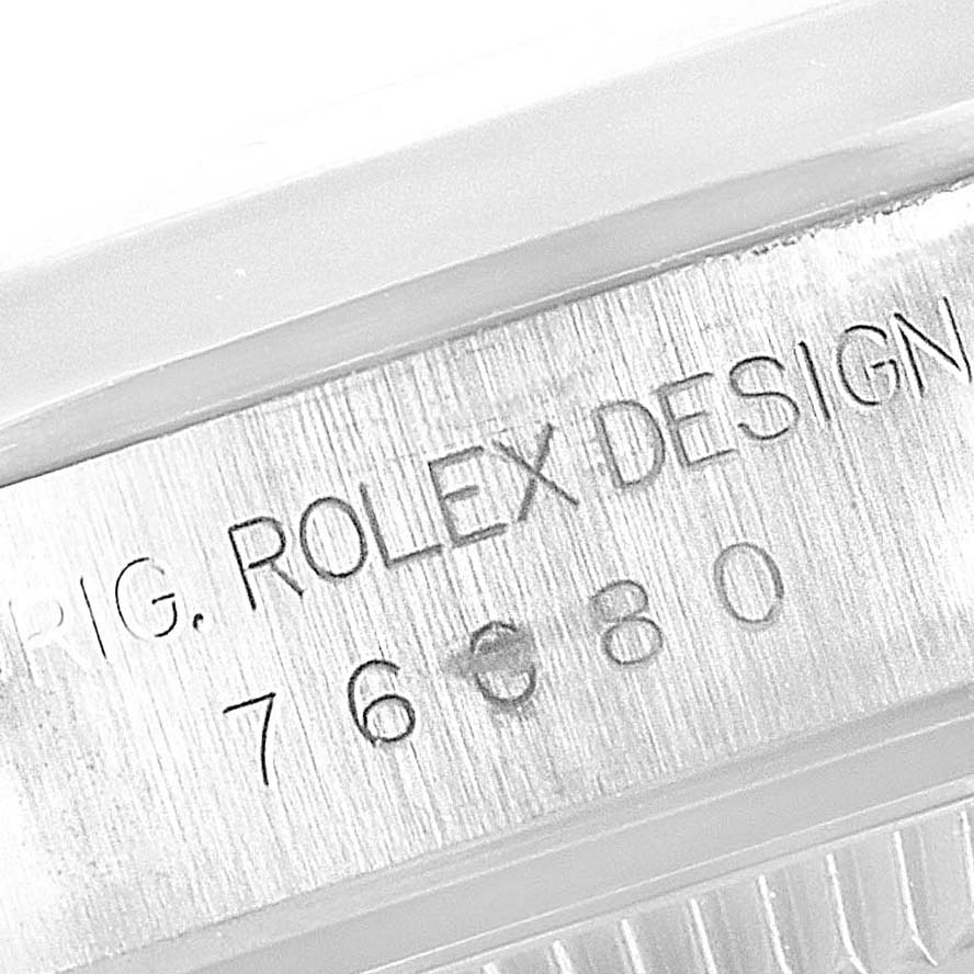 This image shows a close-up of the case back and serial number of a Rolex Oyster Perpetual 76080 Women
s Stainless Steel Pink Dial 76080 Women
s Stainless Steel Pink Dial watch.