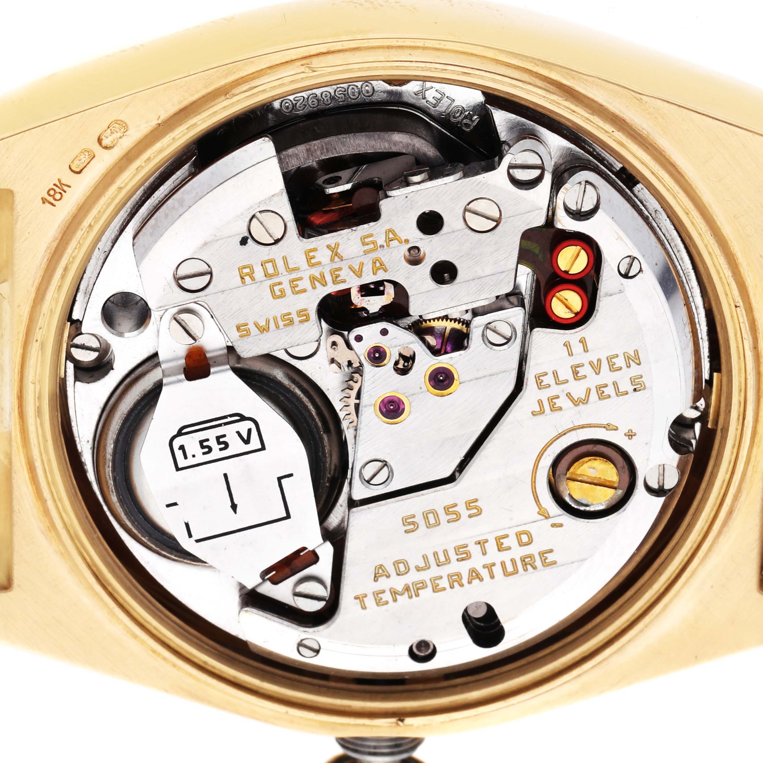 The image shows the back view of a Rolex Oysterquartz 19018 Men's Yellow Gold Champagne Dial watch, revealing its internal movement and components.