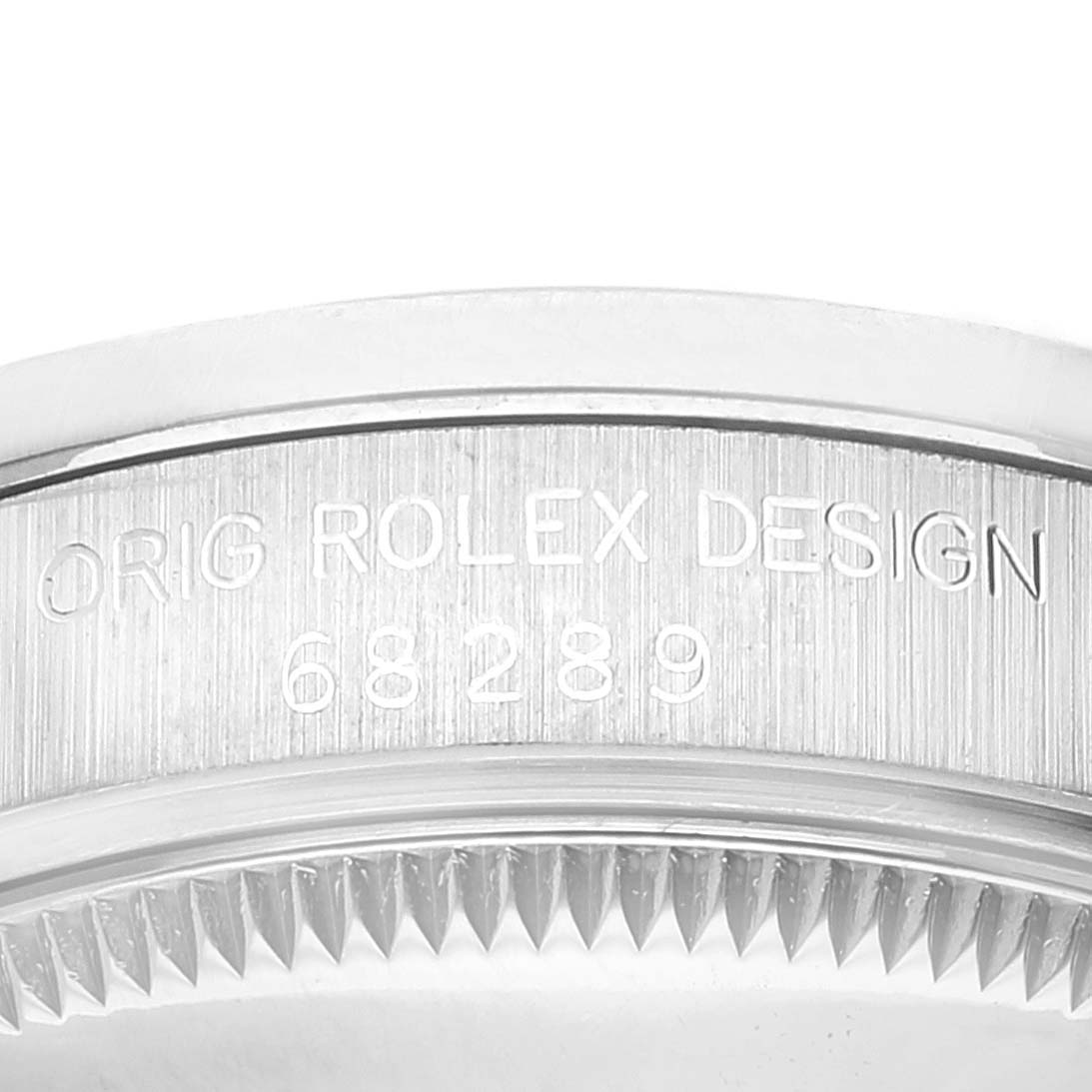 This image shows a close-up of the engraved side of the Rolex President 68289 Women's White Gold Silver Dial 68289 Women's White Gold Silver Dial model's bezel.