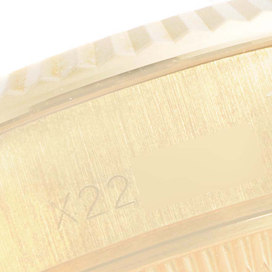 The image shows a close-up of the side case and fluted bezel of a Rolex President 69178 Women
s Yellow Gold Champagne Dial 69178 Women
s Yellow Gold Champagne Dial model watch, highlighting engraved markings.