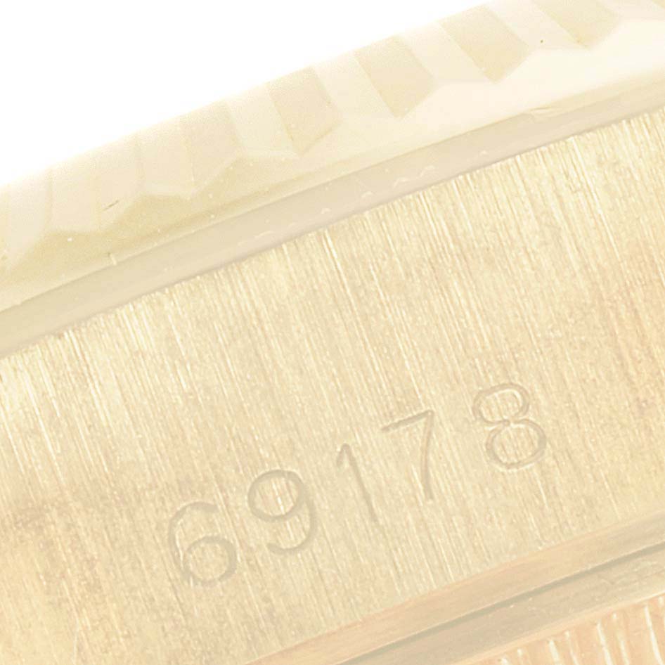This image shows an angled close-up of the serial number engravings on the side of a Rolex President 69178 Women
s Yellow Gold Champagne Dial 69178 Women
s Yellow Gold Champagne Dial model watch.
