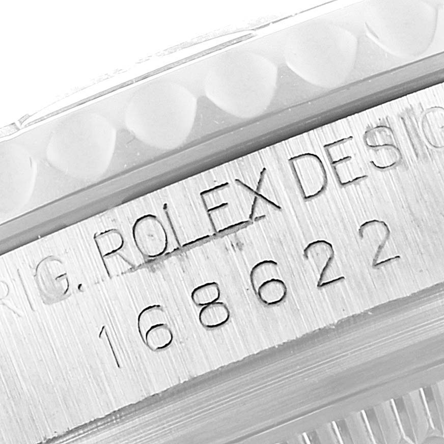 This is a close-up view of the Rolex Yacht-Master 168622 Men's Stainless Steel Silver Dial 168622 Men's Stainless Steel Silver Dial watch, focusing on the engraved text and serial number.