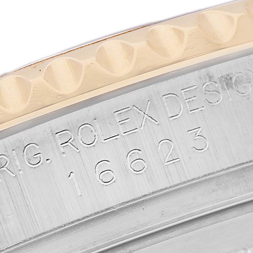 The image shows a close-up of the engraved case side of a Rolex Yacht-Master 16623 Men
s Steel and Gold (two tone) Mother of Pearl Dial, highlighting the model number and design details.