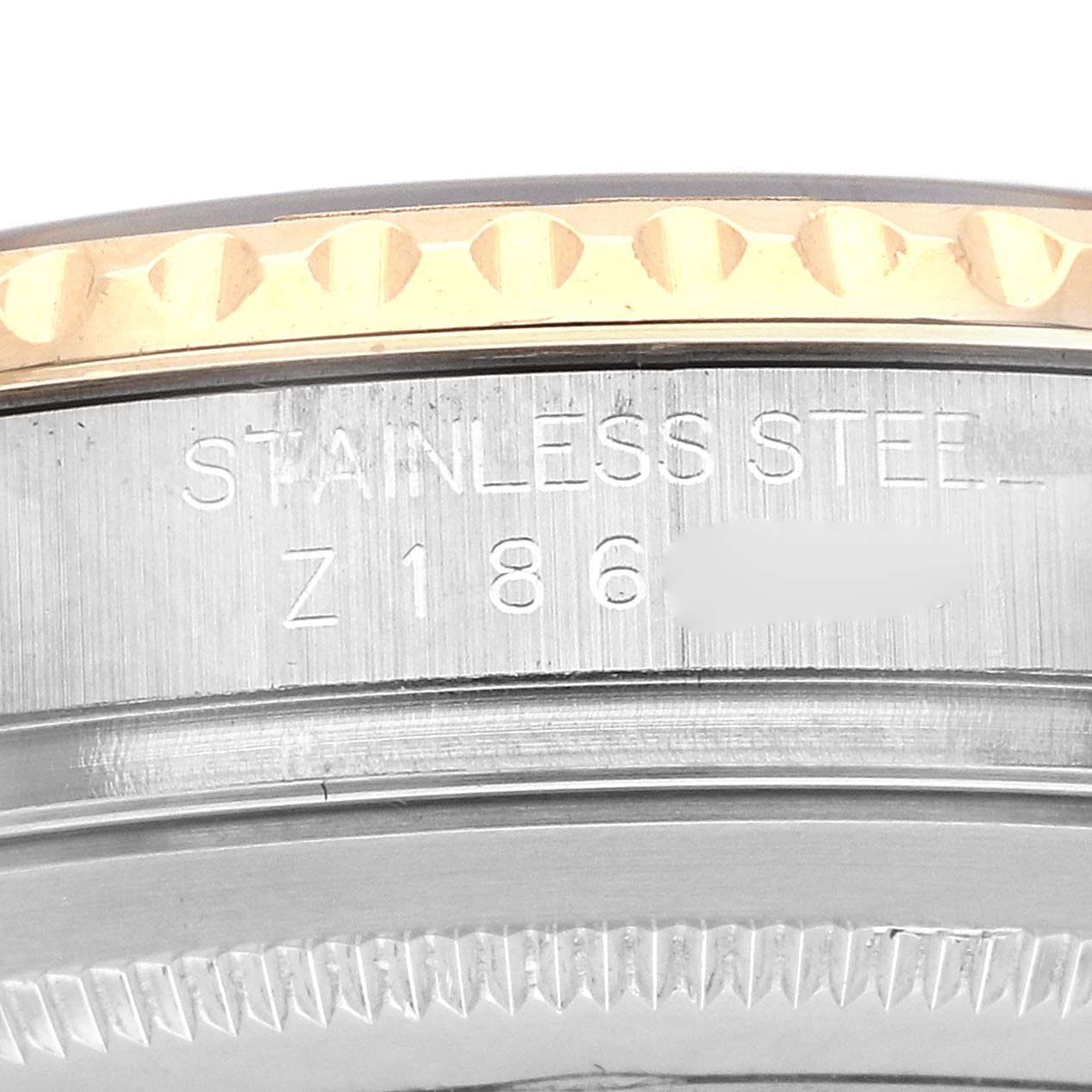 The image shows a close-up of the side engraving on a Rolex Yacht-Master 16623 Men
s Steel and Gold (two tone) Blue Dial watch bezel.