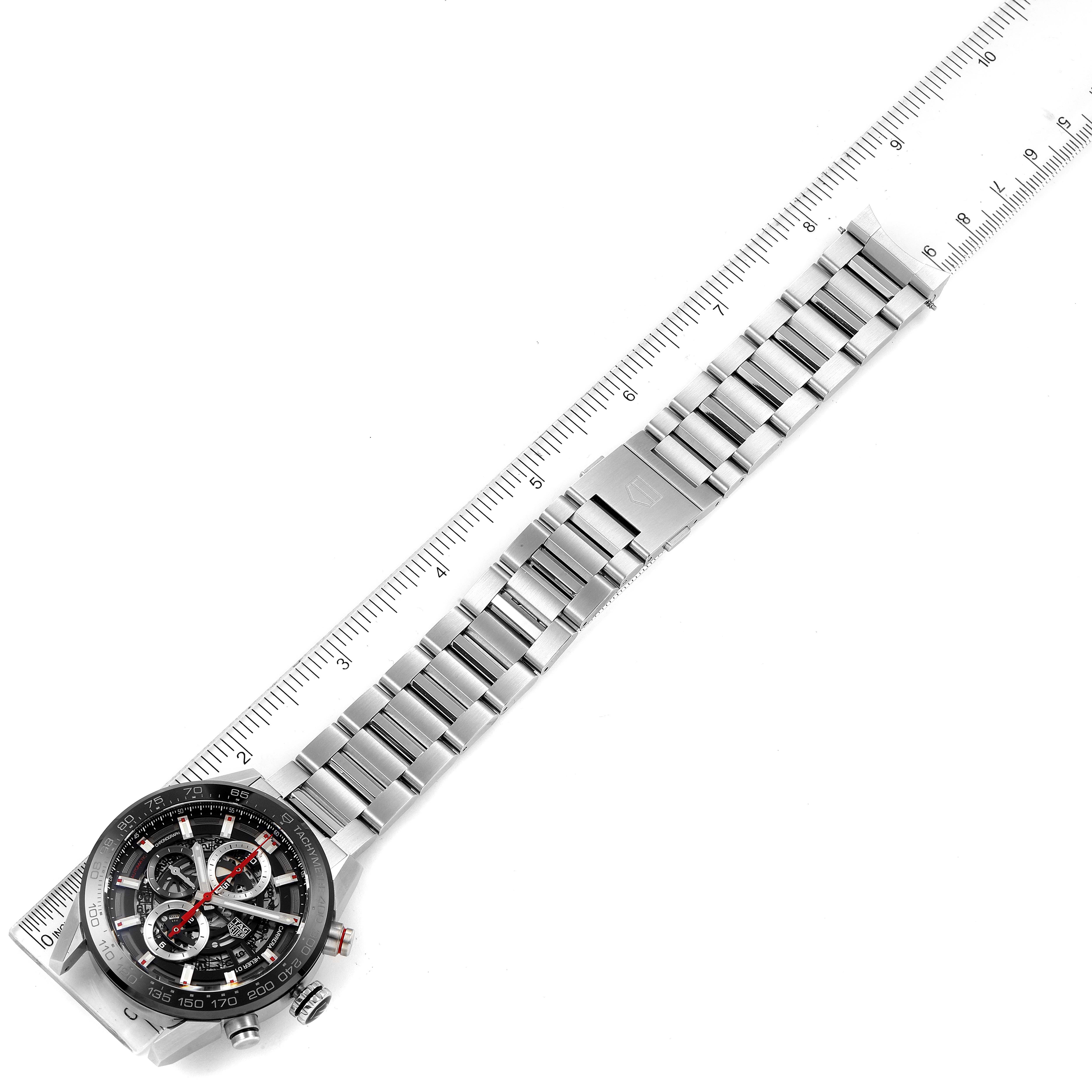 The image shows the front view of a Tag Heuer Carrera CAR201V.BA0714 Men
s Stainless Steel Black Dial CAR201V.BA0714 Men
s Stainless Steel Black Dial watch, focusing on the face and full metal strap, placed along a ruler for scale.
