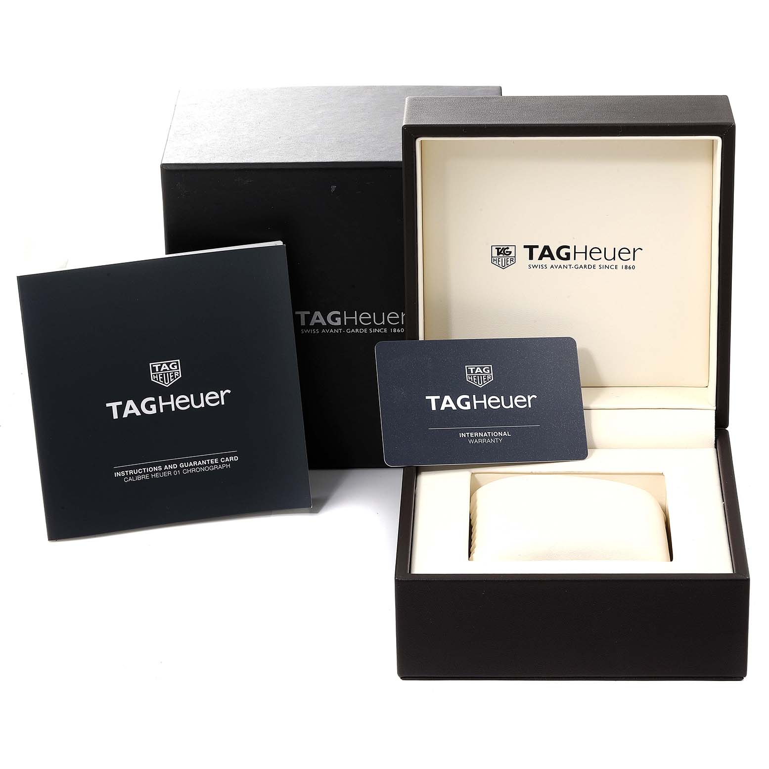 The image shows the packaging and accessories for the Tag Heuer Carrera CAR201V.BA0714 Men
s Stainless Steel Black Dial CAR201V.BA0714 Men
s Stainless Steel Black Dial watch, including the box, instruction manual, and warranty card.