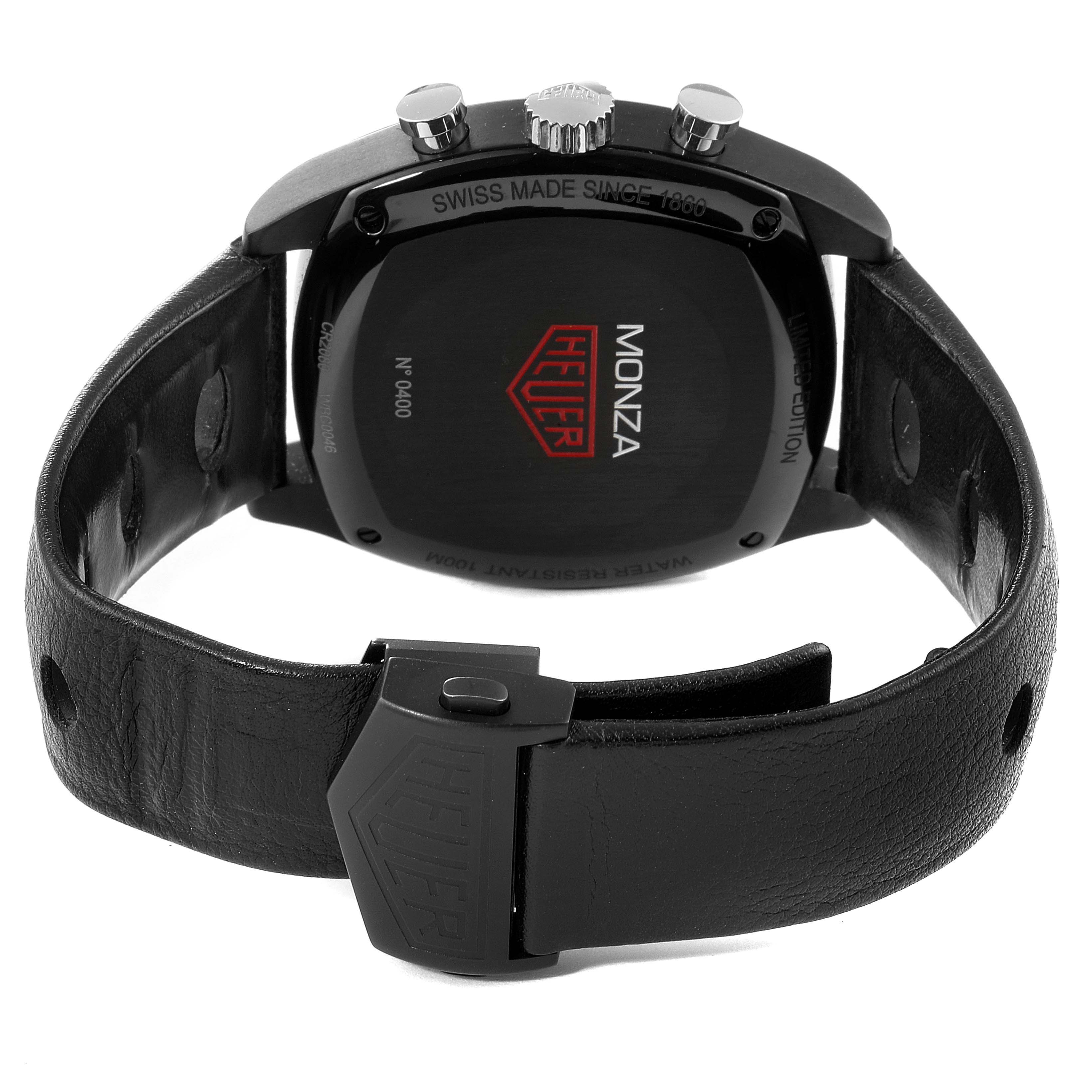 The image shows the back view of a Tag Heuer Monza watch, highlighting its case back, crown, pushers, and leather strap.