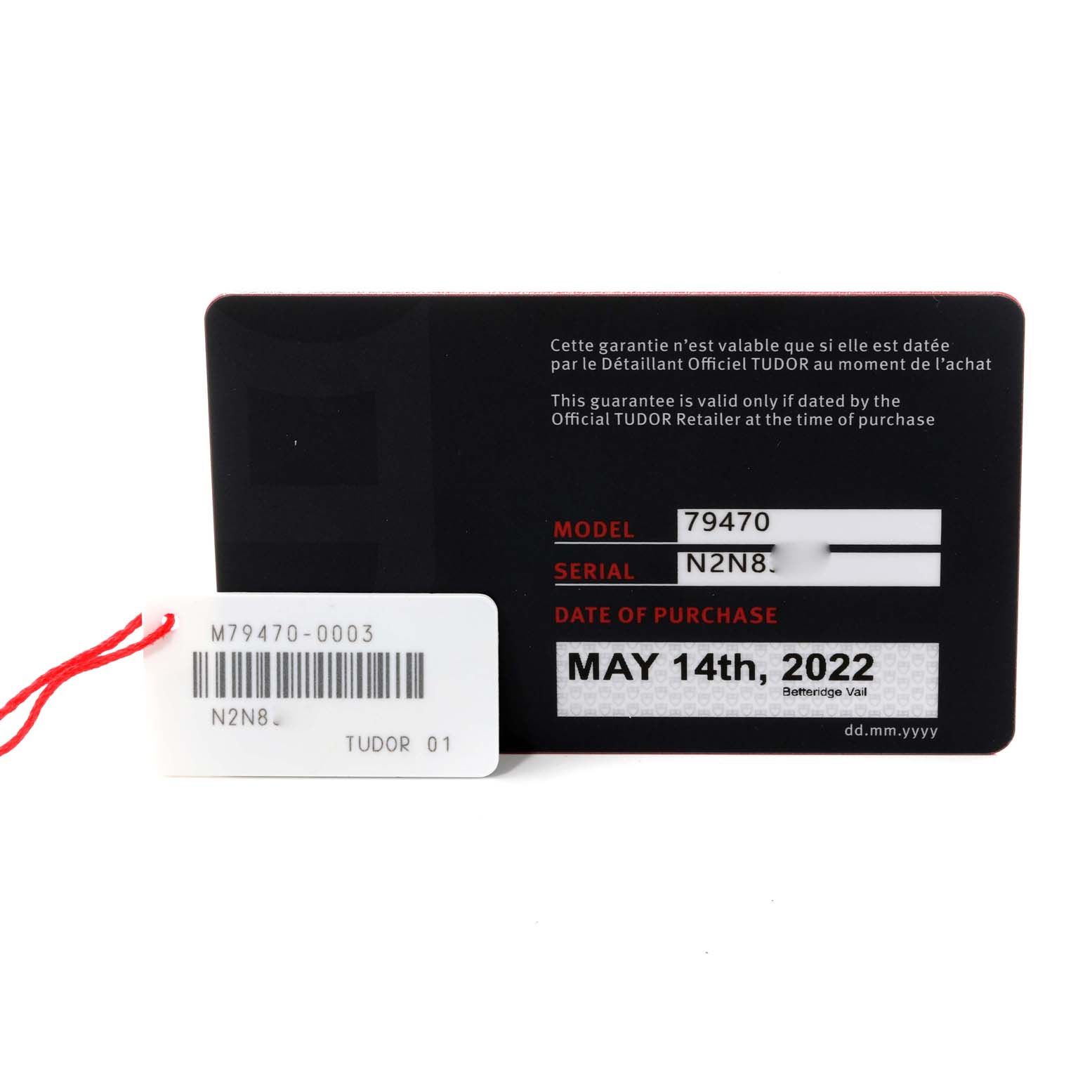 The image shows the warranty card and hang tag for the Tudor Heritage Black Bay M79470-0003 Men
s Stainless Steel Black Dial M79470-0003 Men
s Stainless Steel Black Dial model watch.