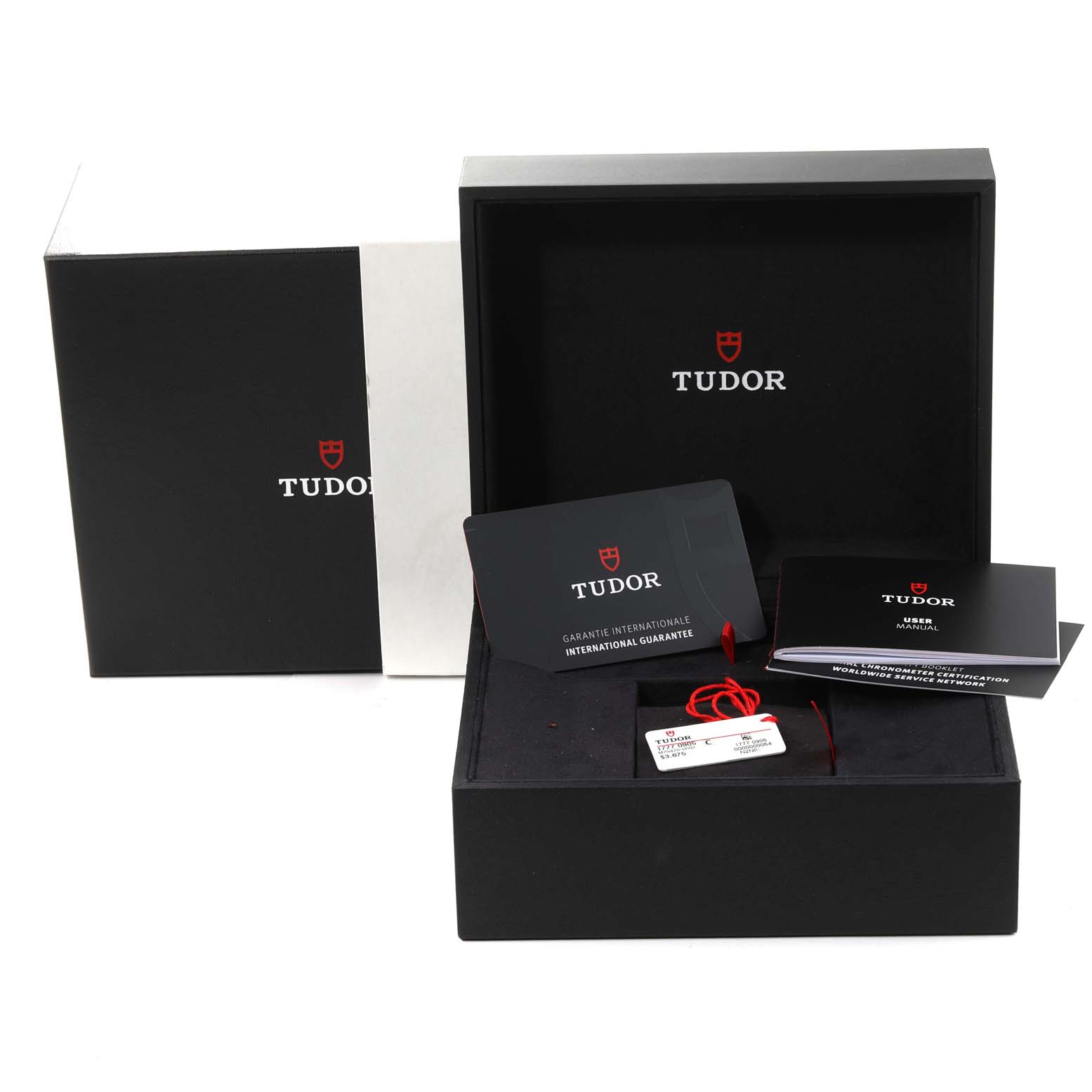 This image shows the open packaging and accessories for a Tudor Heritage Black Bay M79470-0003 Men
s Stainless Steel Black Dial M79470-0003 Men
s Stainless Steel Black Dial watch, including the box, tags, and documents.