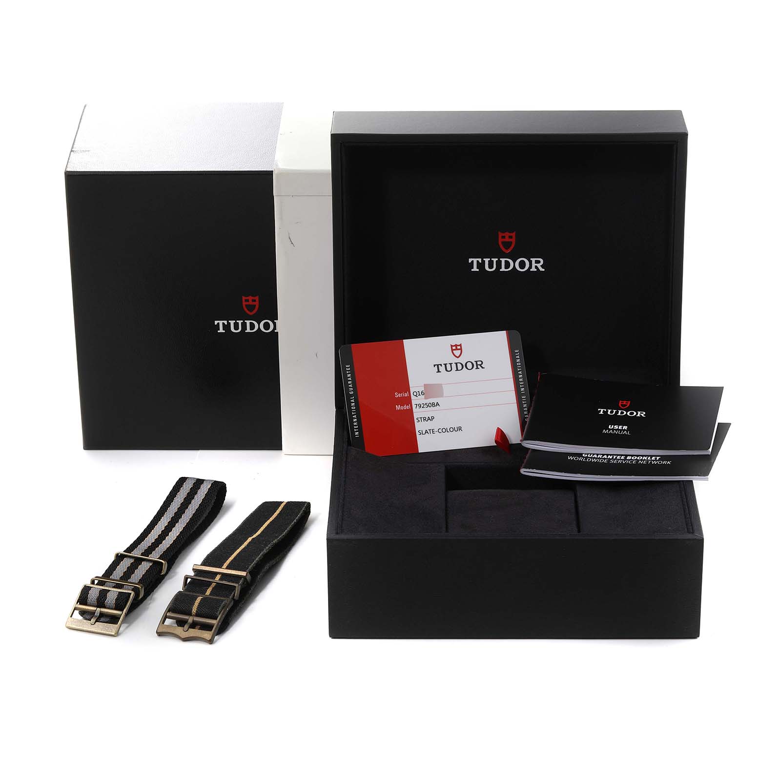 The image shows Tudor Heritage Black Bay 79250BA Men's Bronze Black Dial 79250BA Men's Bronze Black Dial watch accessories including straps, warranty card, and user manual in a box.