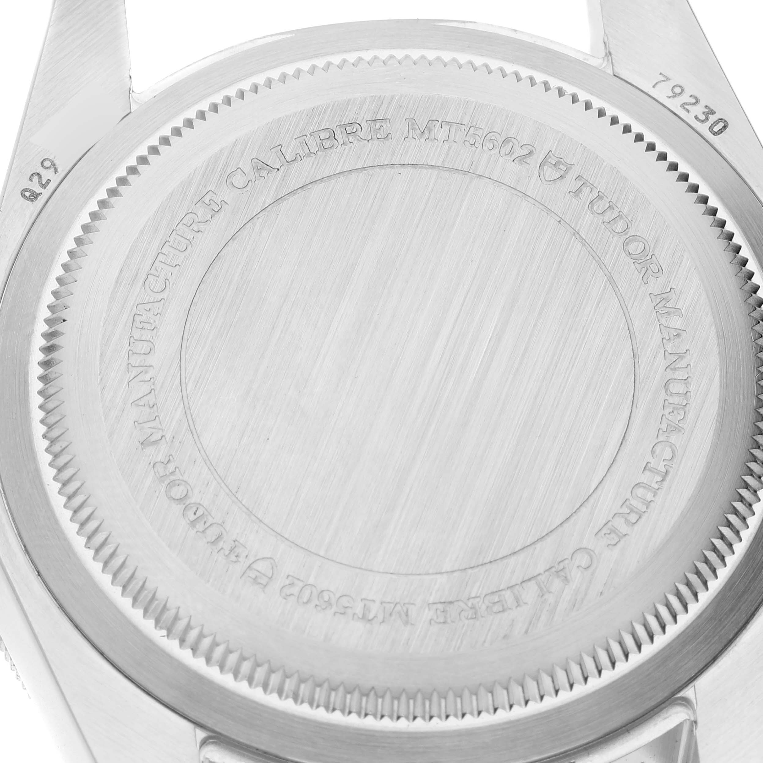 The image shows the case back of the Tudor Heritage Black Bay 79230 Men
s Stainless Steel Black Dial 79230 Men
s Stainless Steel Black Dial watch, highlighting its "Calibre MT5602" inscription.