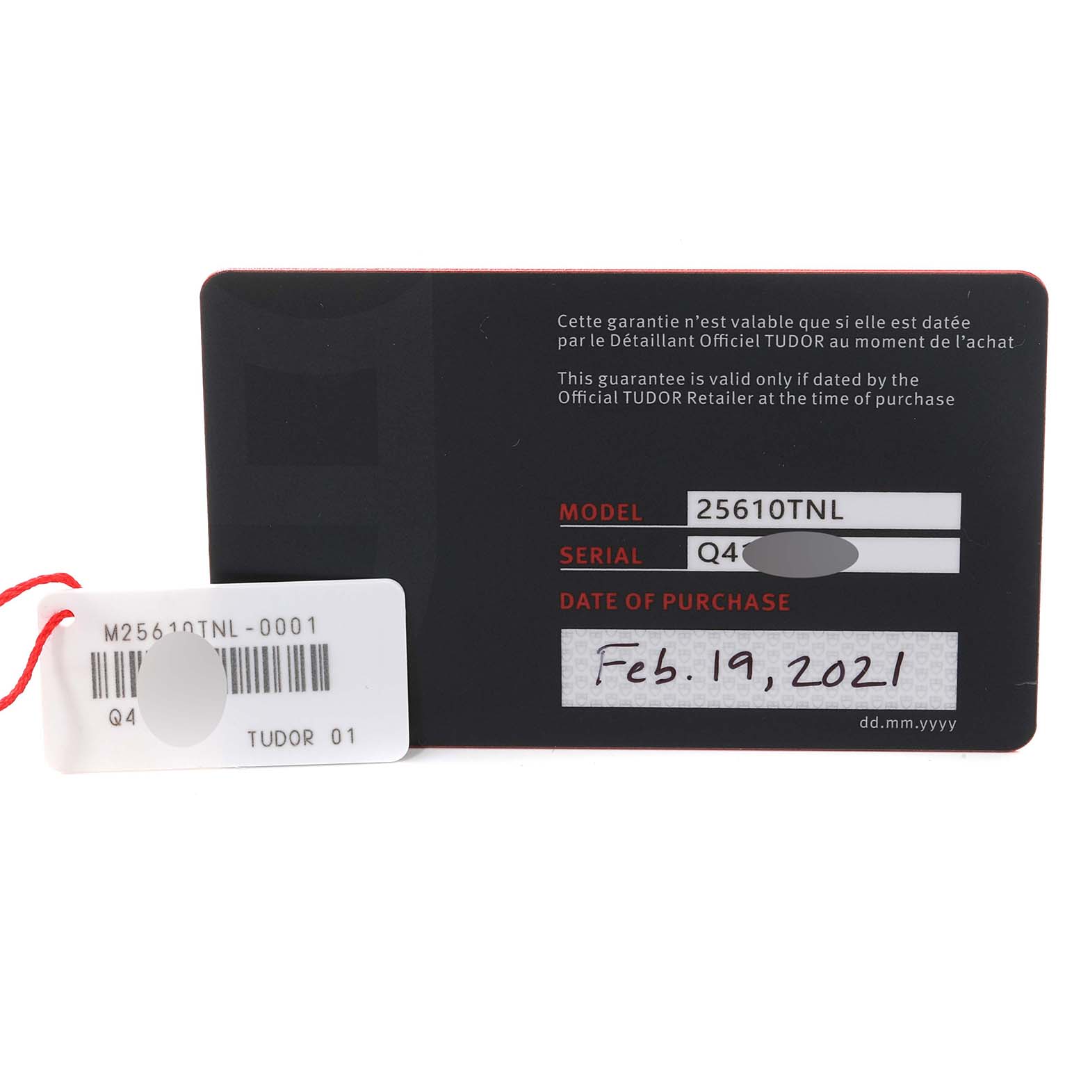 The image shows the warranty card and a tag for the Tudor Pelagos 25610TNL Men
s Titanium Black Dial 25610TNL Men
s Titanium Black Dial model 25610TNL watch, including serial and purchase date details.