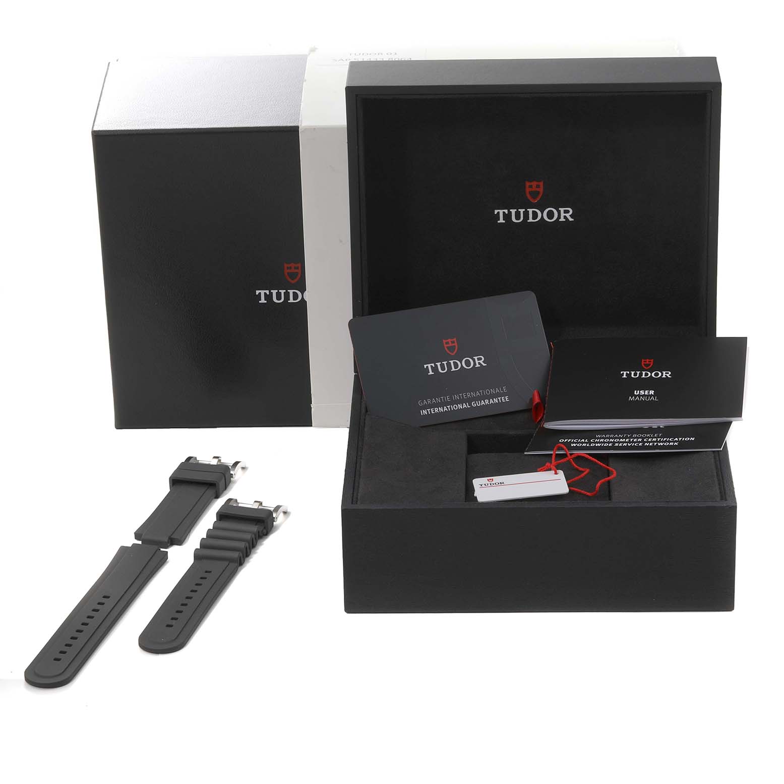 The image shows the packaging, user manual, international guarantee card, spare straps, and accessories for a Tudor Pelagos 25610TNL Men
s Titanium Black Dial 25610TNL Men
s Titanium Black Dial watch.