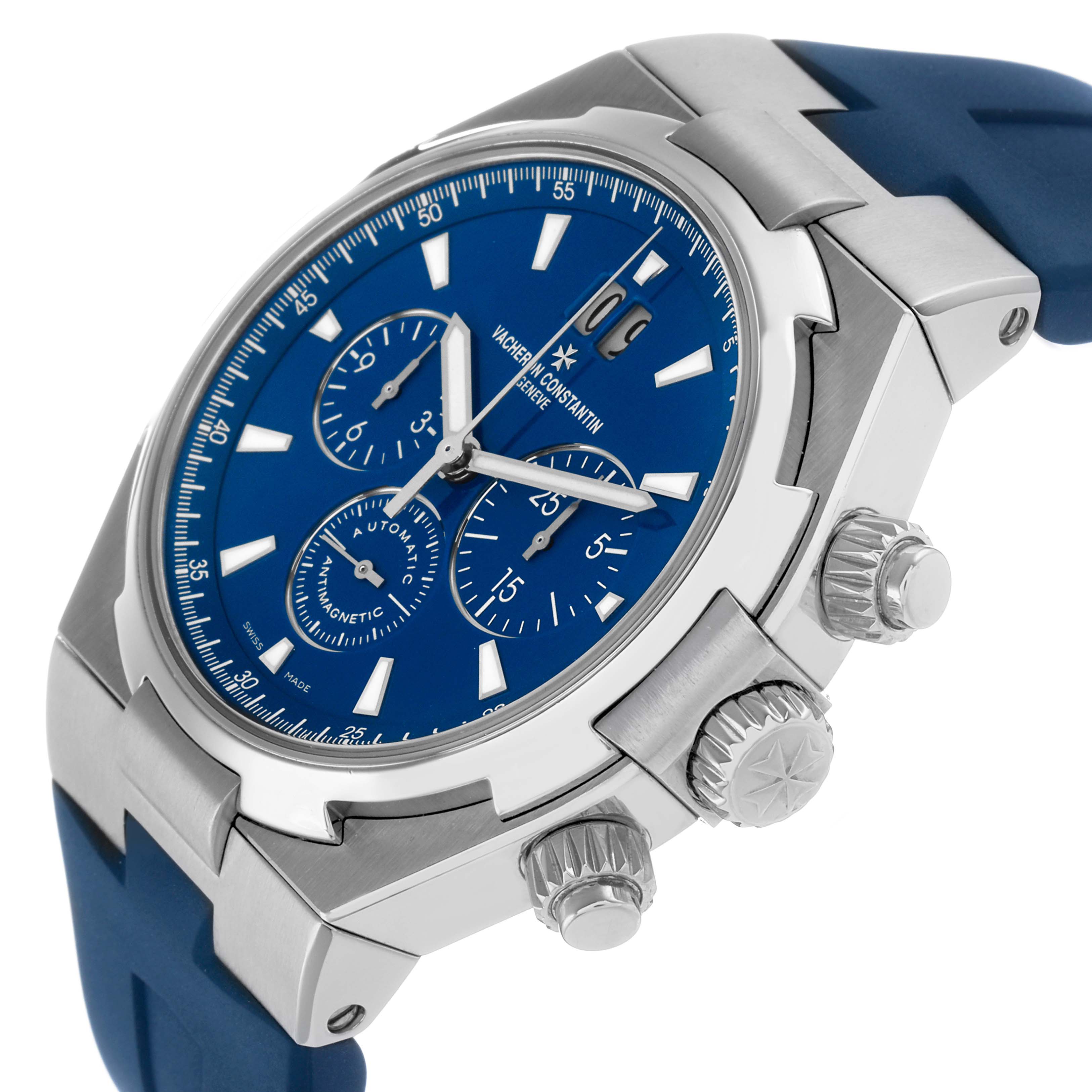 The Vacheron Constantin Overseas 49150 Men's Stainless Steel Blue Dial watch is shown at an angled side view, displaying its blue dial, chronograph subdials, and crown.