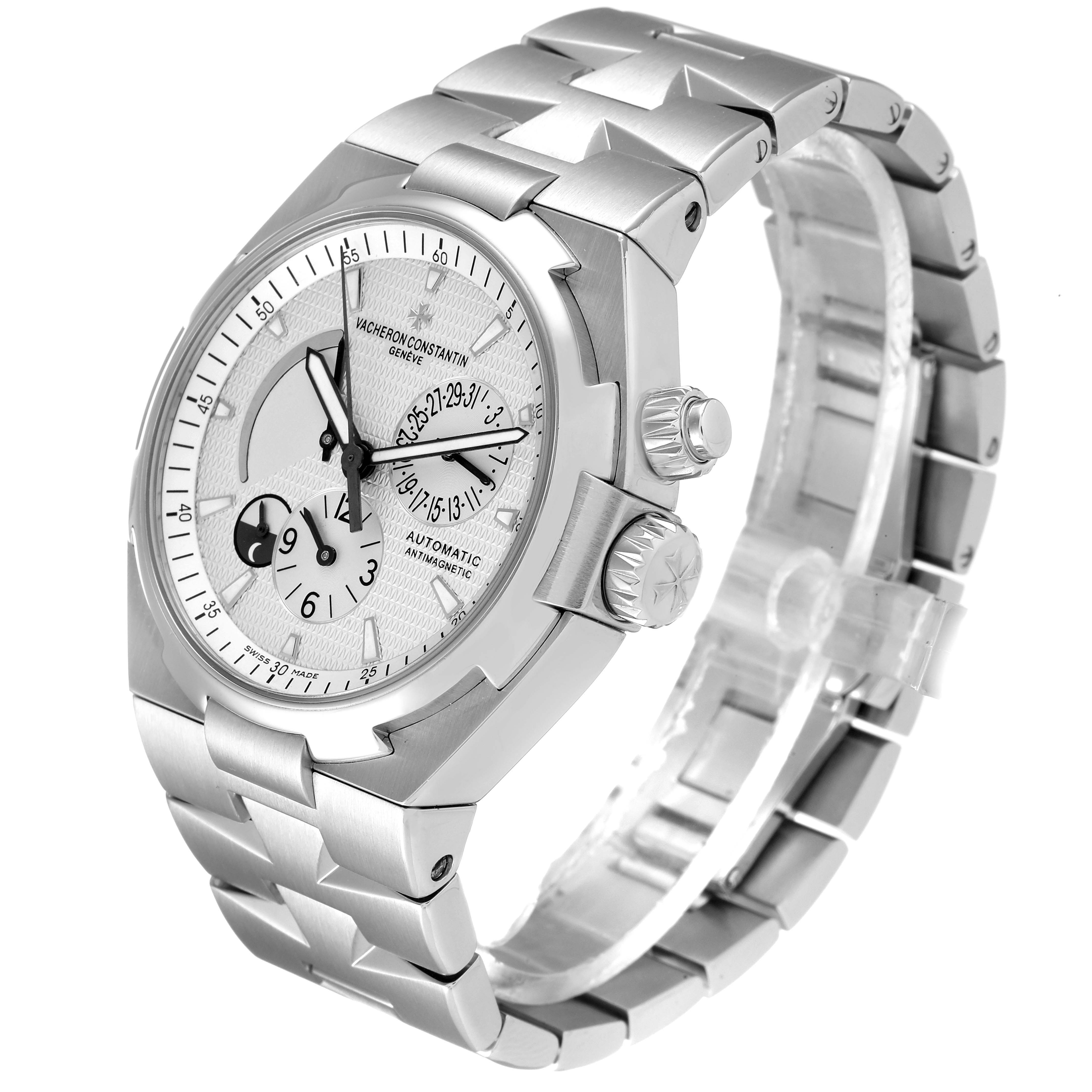 The image shows a Vacheron Constantin Overseas 47450/B01A-9226 Men
s Stainless Steel Silver Dial 47450/B01A-9226 Men
s Stainless Steel Silver Dial watch from an angled side view, highlighting the watch face, bezel, crown, and bracelet.