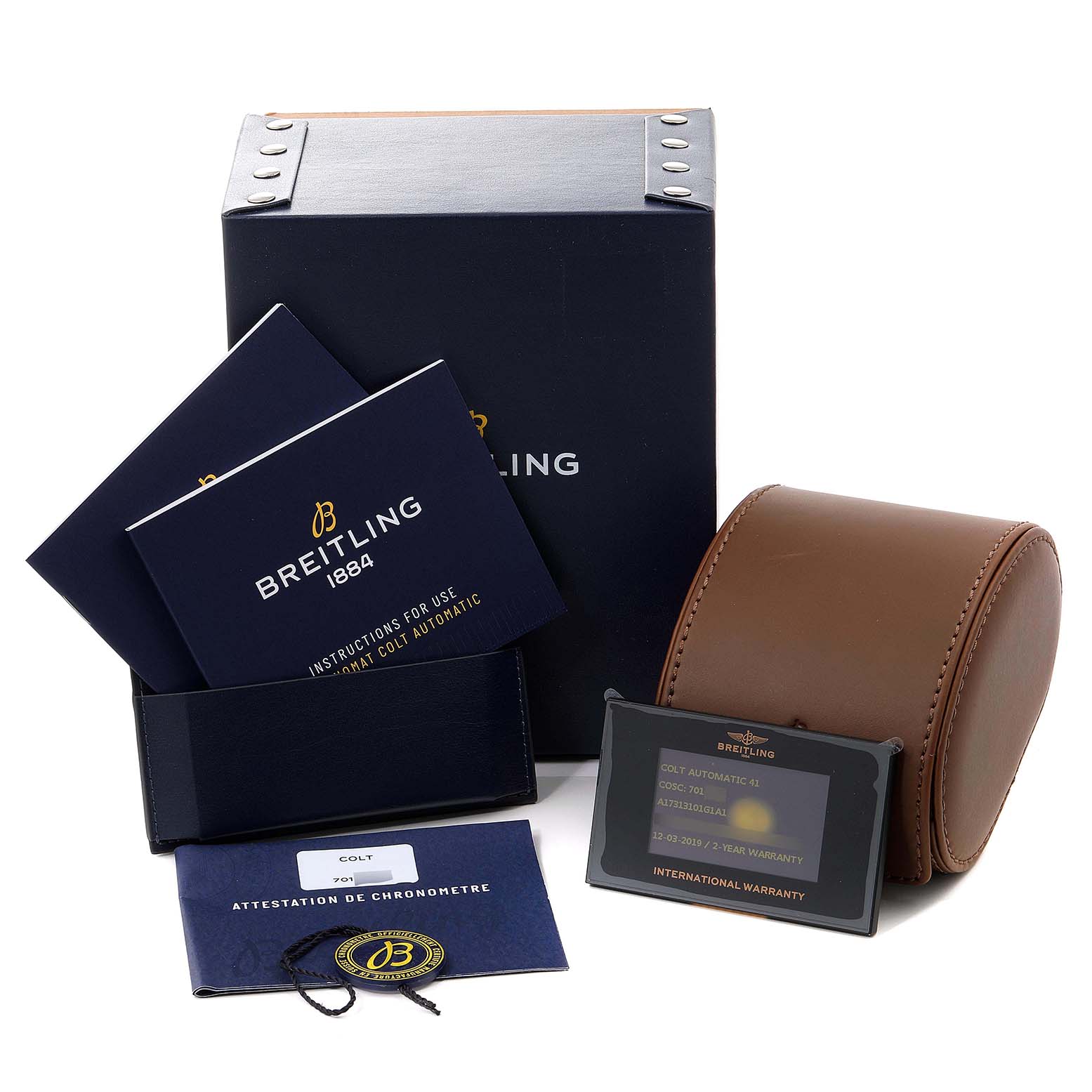 The image showcases the Breitling Colt A17313 Men's Stainless Steel White Dial A17313 Men's Stainless Steel White Dial model's packaging, manuals, warranty card, and a leather watch case.