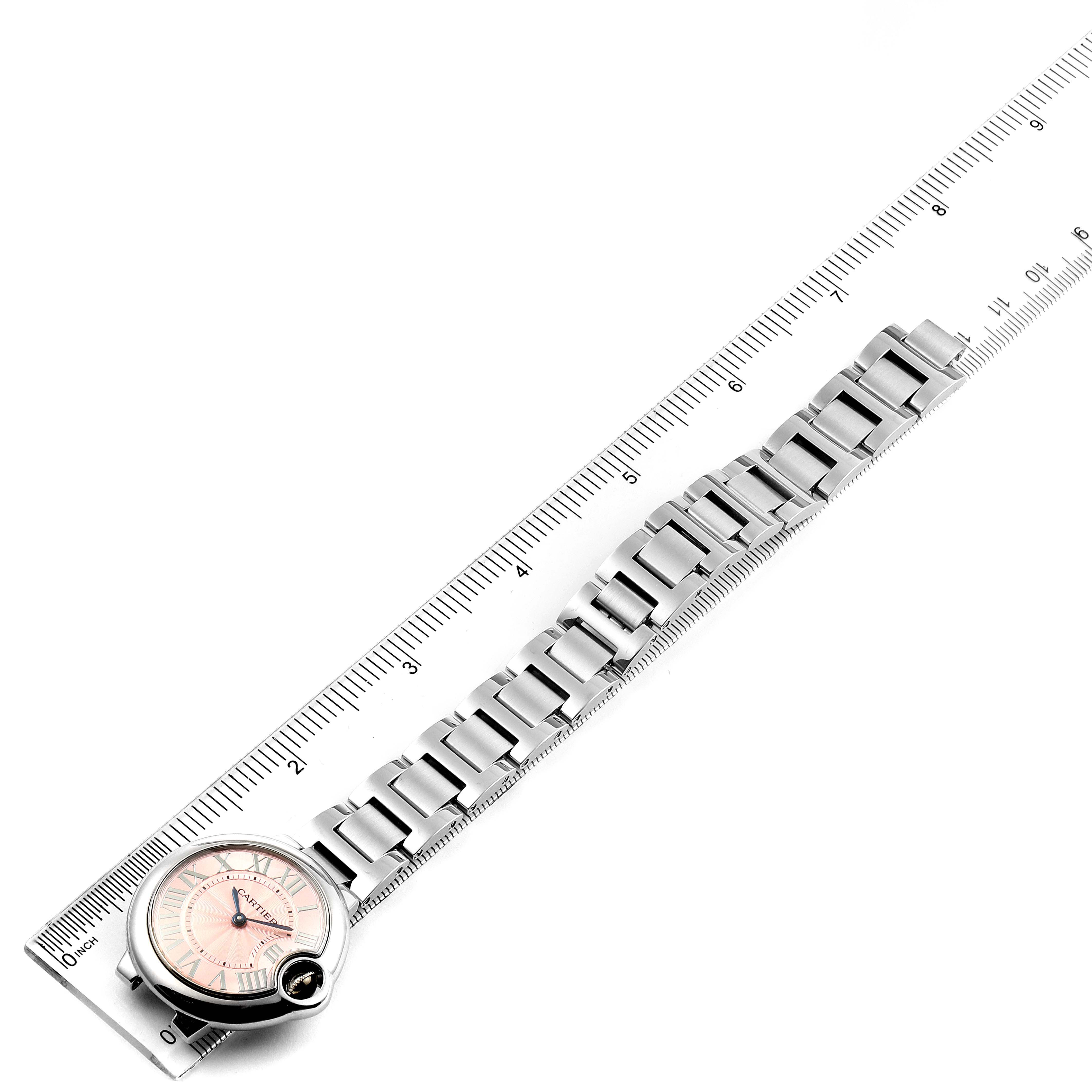 The Cartier Ballon Bleu WSBB0033 Women's Stainless Steel Pink Dial WSBB0033 Women's Stainless Steel Pink Dial watch is shown from an overhead angle, displaying the bracelet and dial against a ruler.