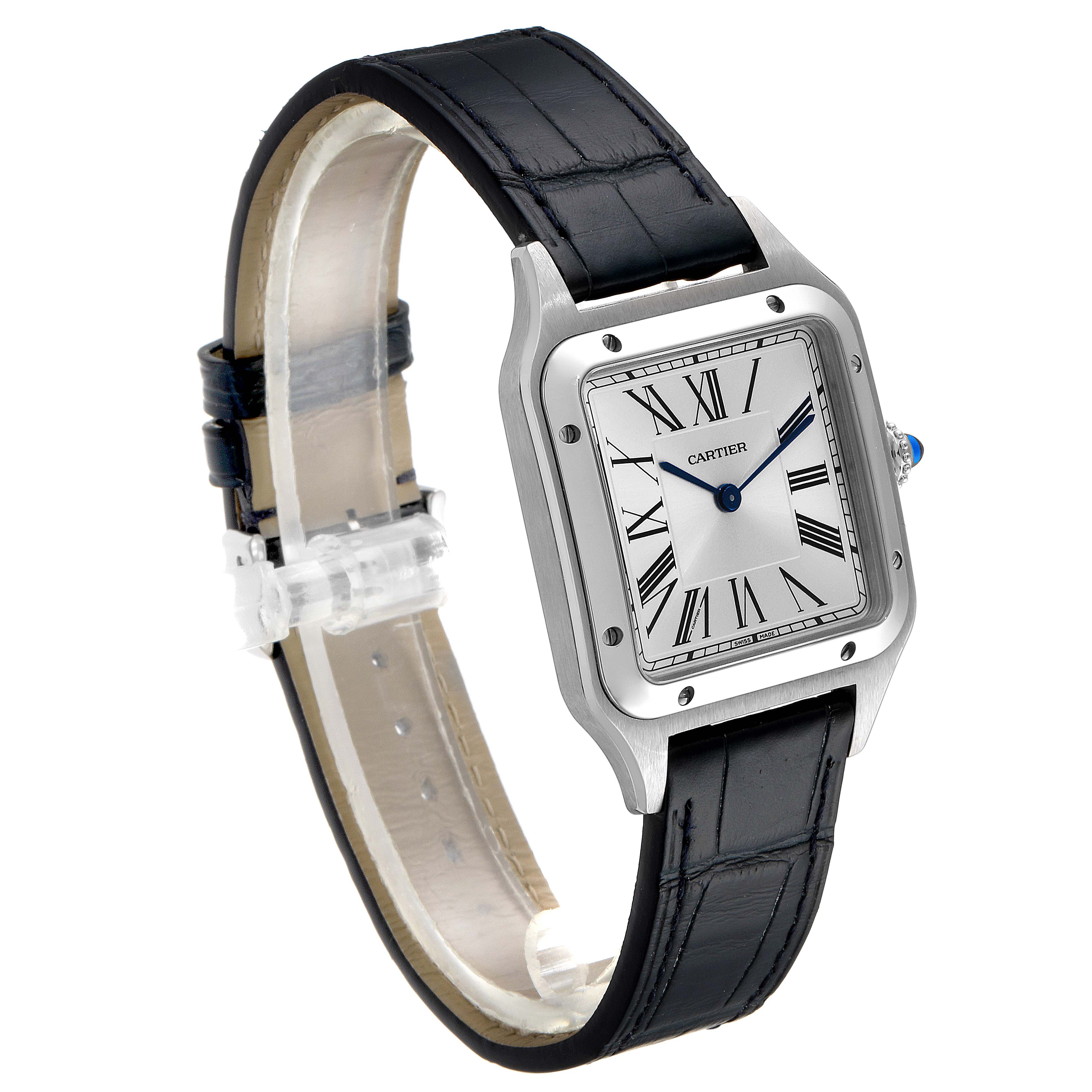 The image shows a Cartier Santos Dumont WSSA0022 Men
s Stainless Steel Silver Dial WSSA0022 Men
s Stainless Steel Silver Dial watch at an angle, highlighting the face, bezel, and black leather strap.