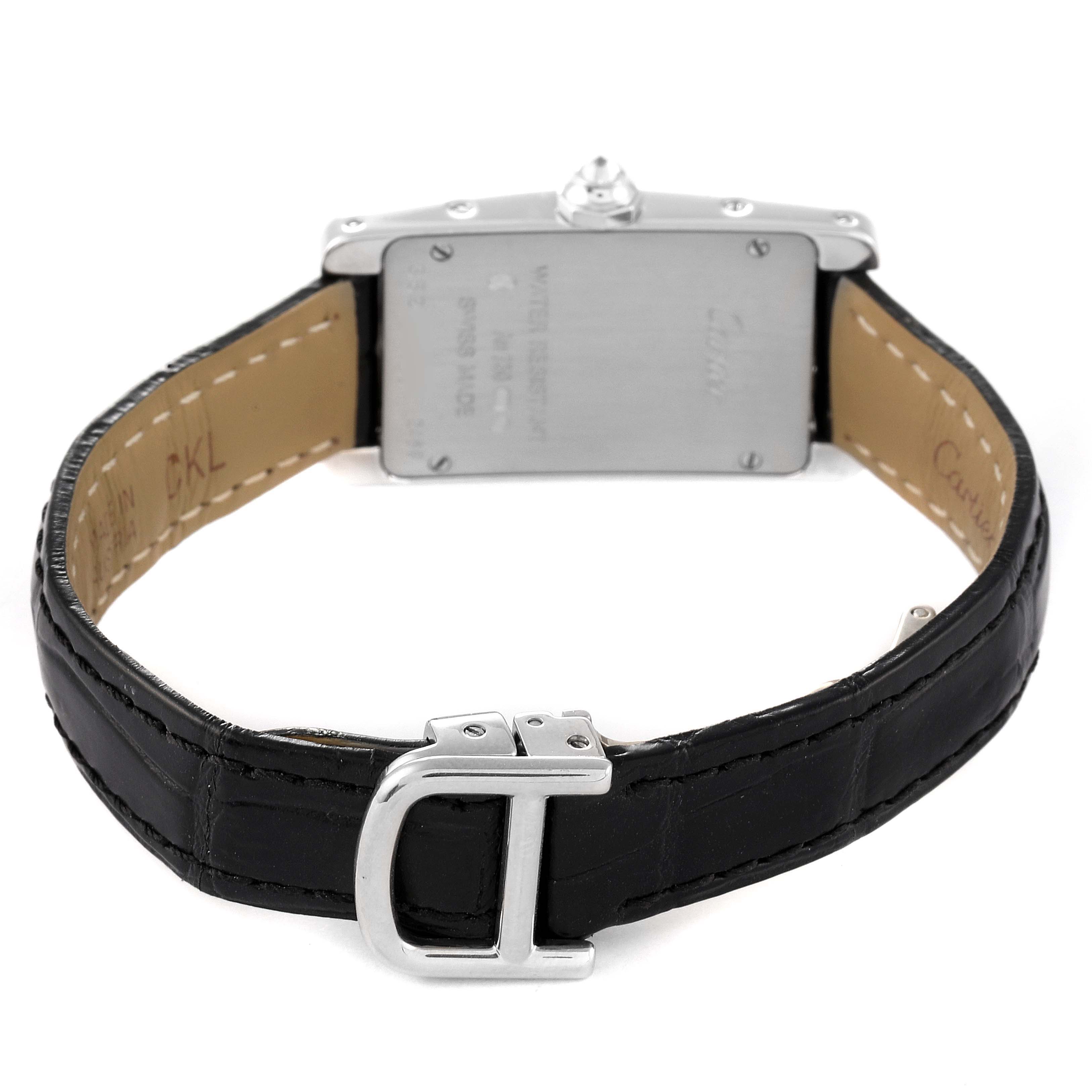 The image shows the back view of a Cartier Tank Americaine 2489 Women's White Gold Silver Dial 2489 Women's White Gold Silver Dial watch, displaying its case back and black leather strap with a buckle.