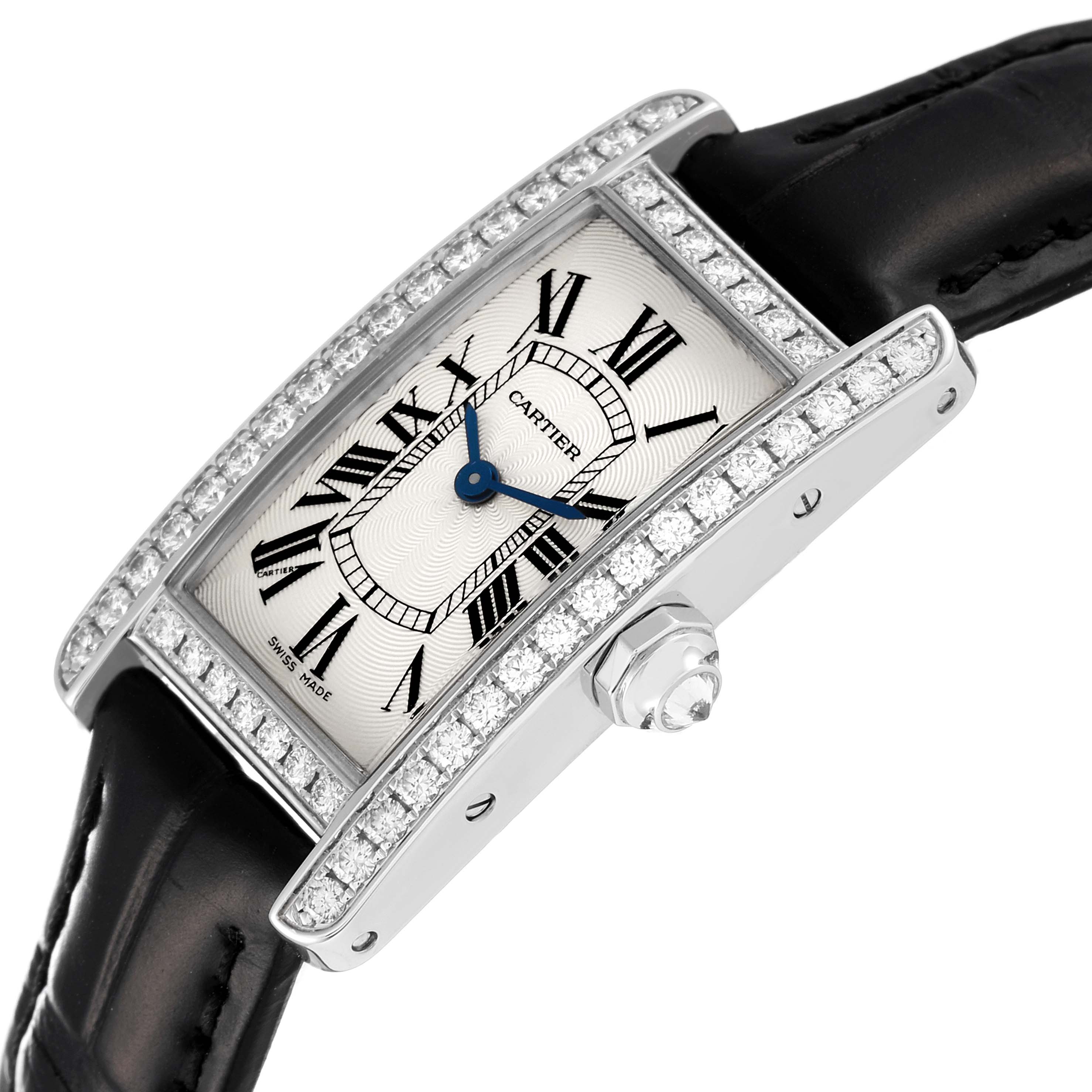 This image shows a Cartier Tank Americaine 2489 Women's White Gold Silver Dial 2489 Women's White Gold Silver Dial watch at a diagonal angle, highlighting its bejeweled face and black leather strap.